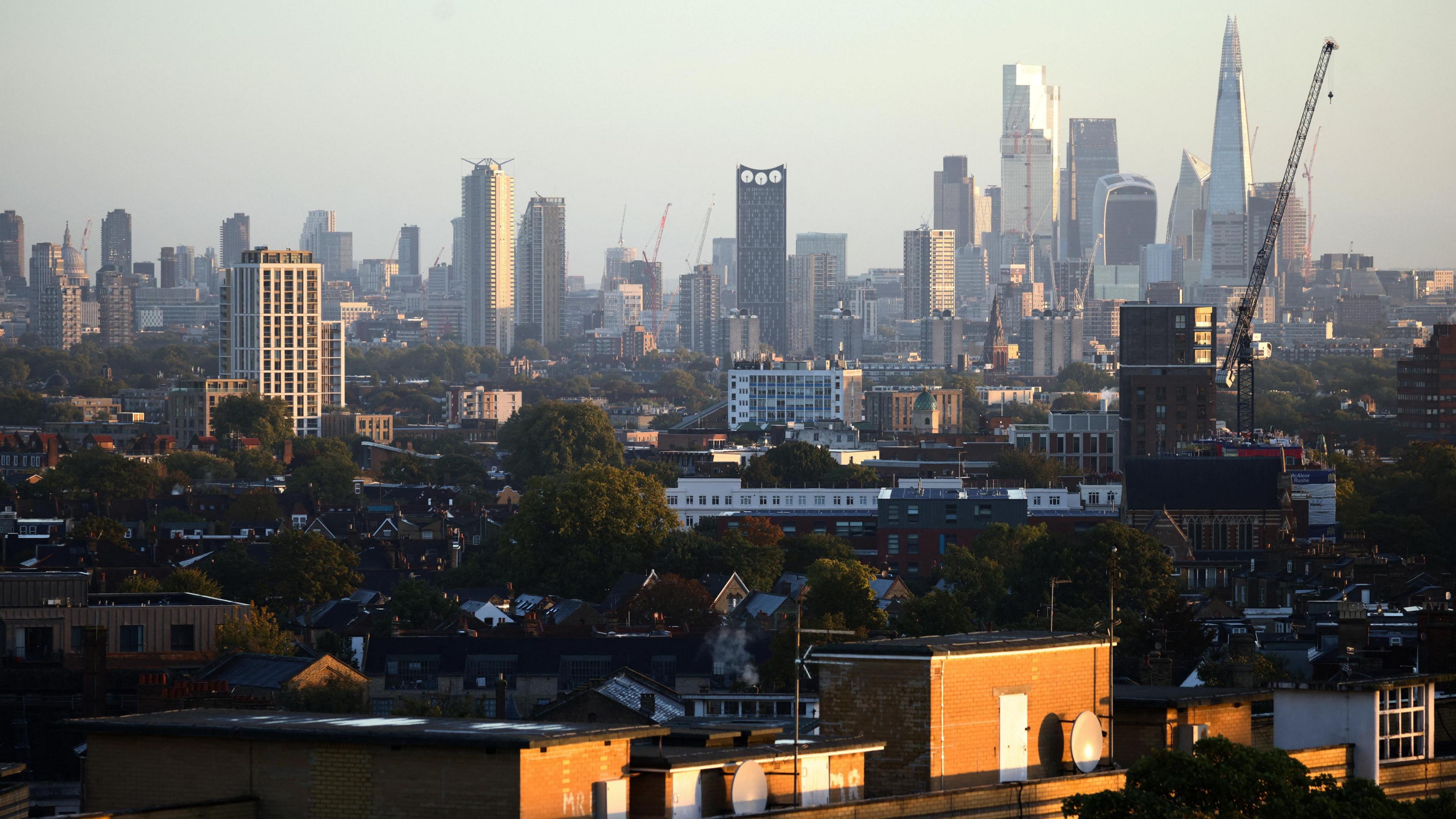 File image of residential rooftops in front of a backdrop of London skyscrapers.