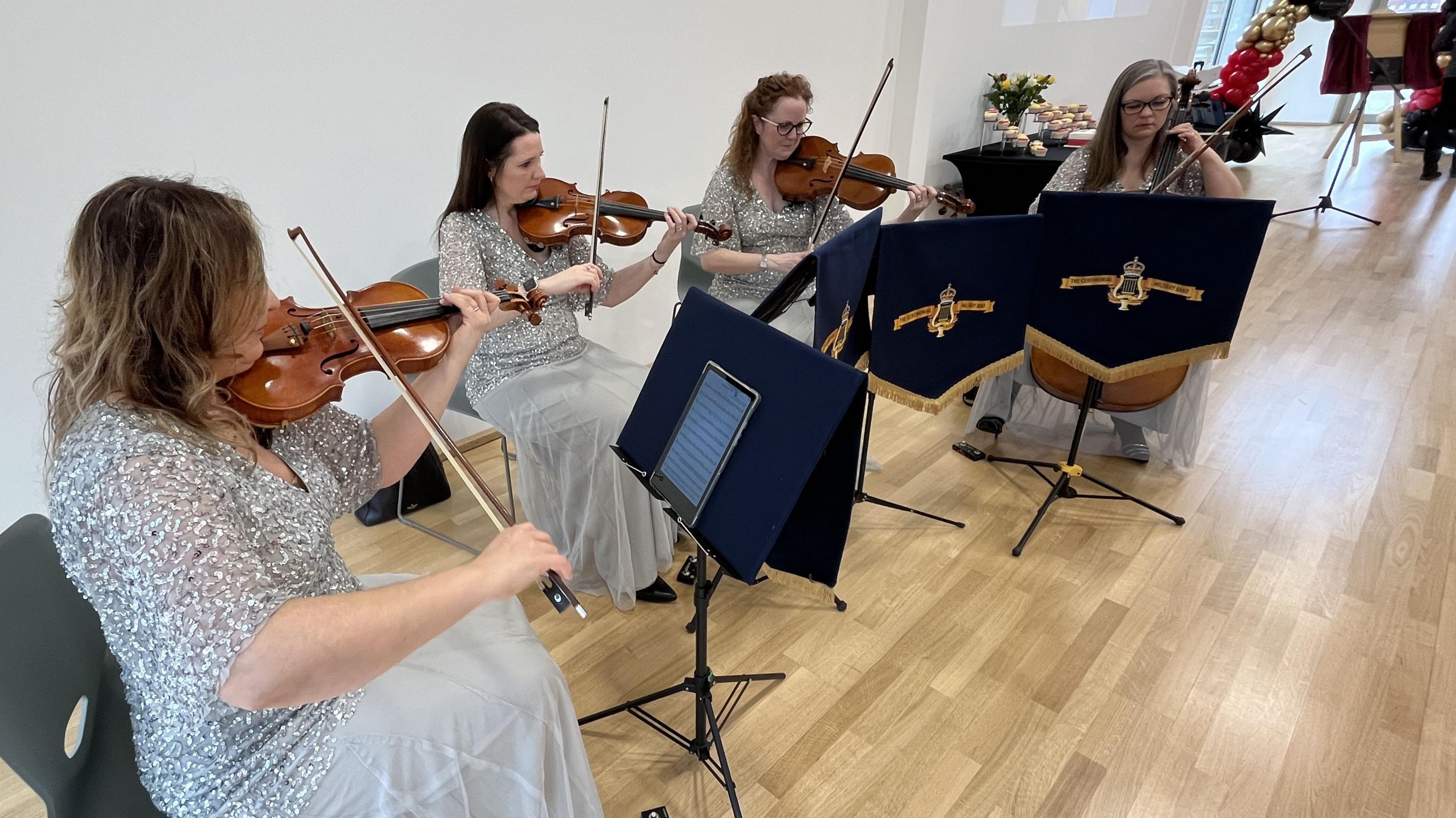 The Ceremonial String Quartet playing violins inside the Civic Centre hall