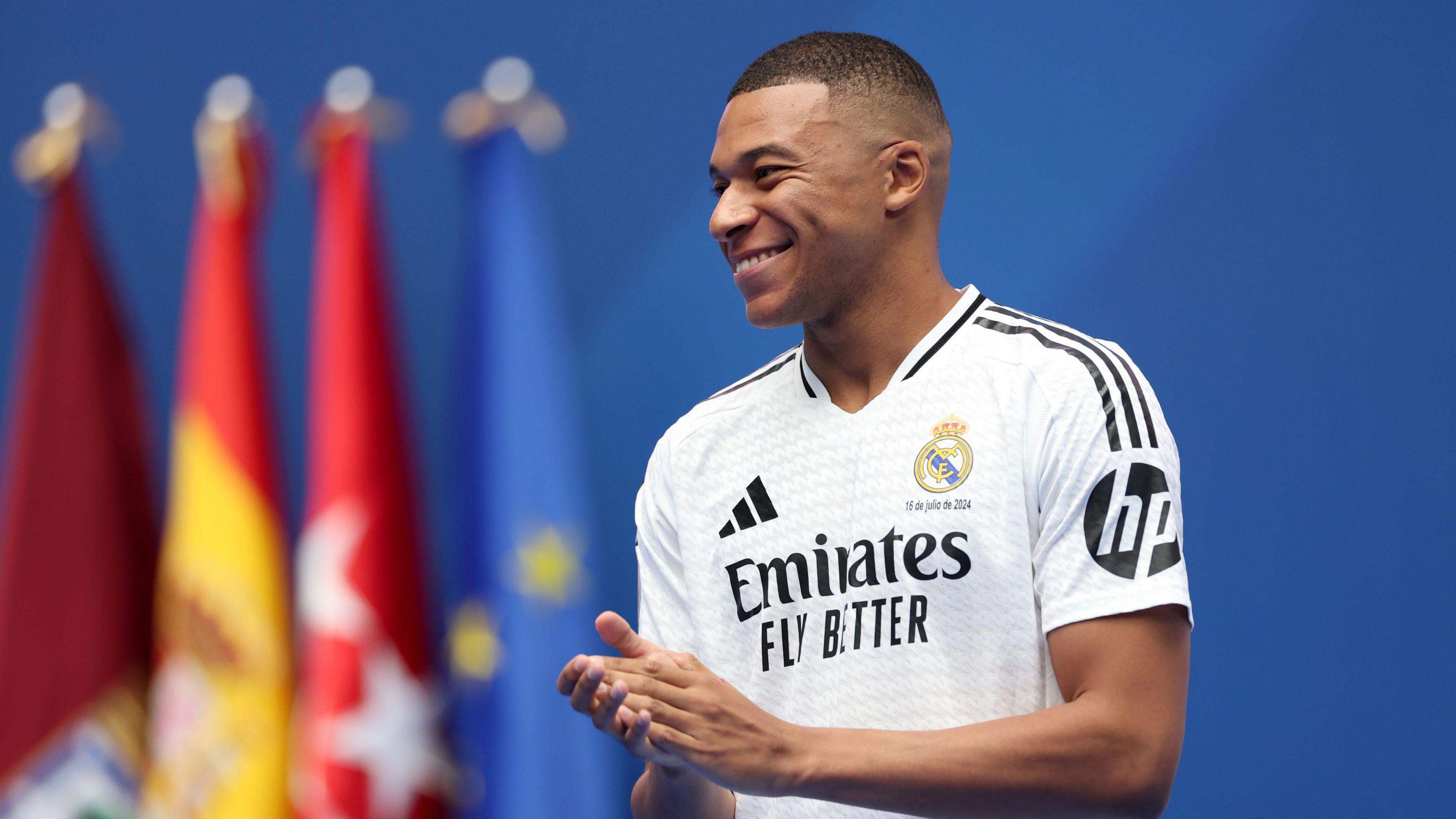 Mbappe smiling in Real Madrid white shirt