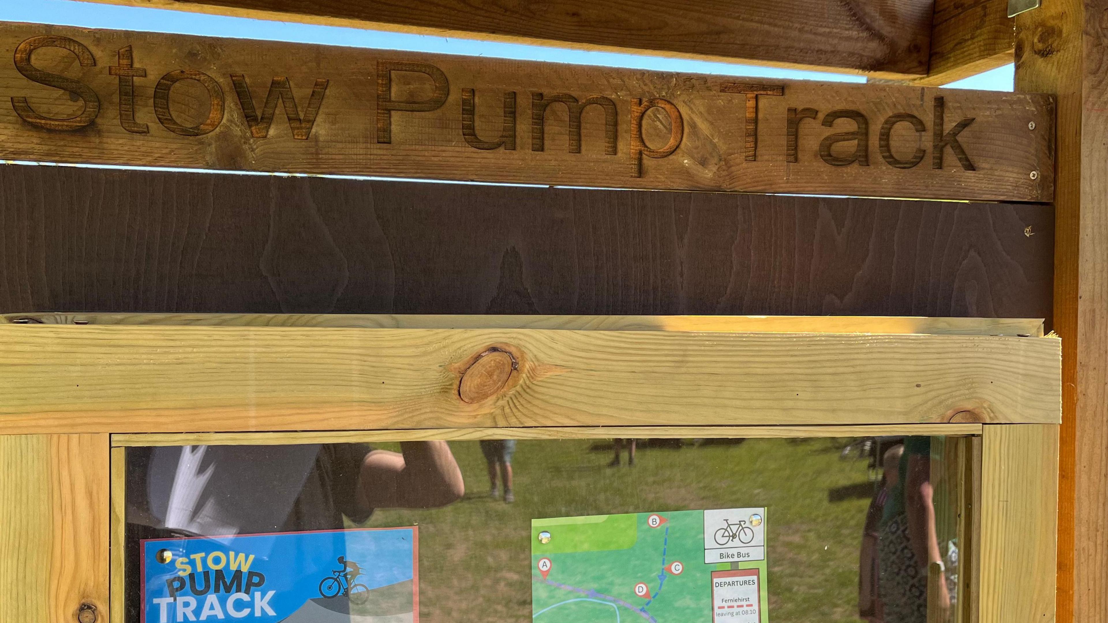 A wooden notice board with the words Stow Pump Track on top