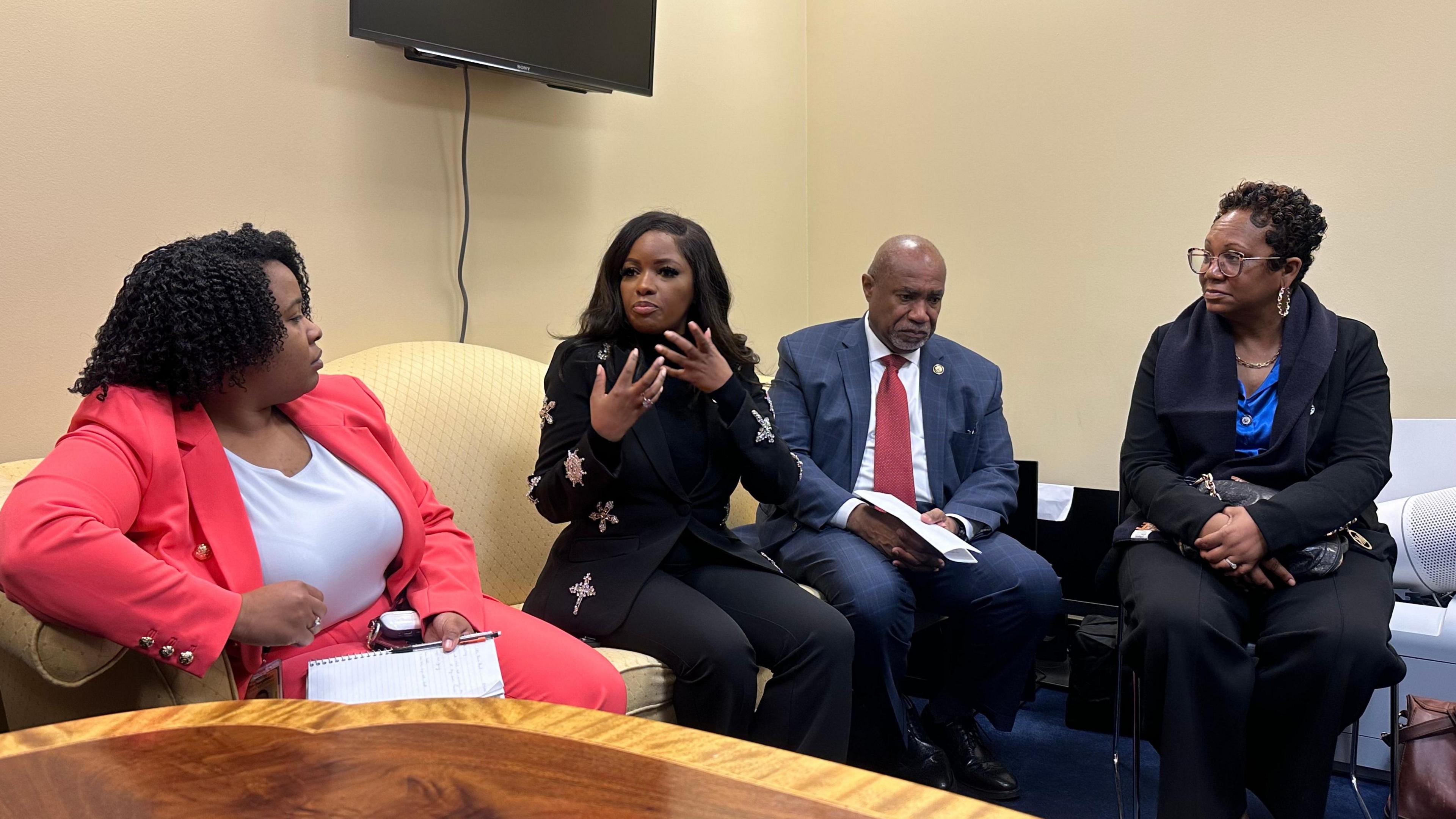 Rep Jasmine Crockett (second from left) sits in a press conference with the Congressional Black Caucus