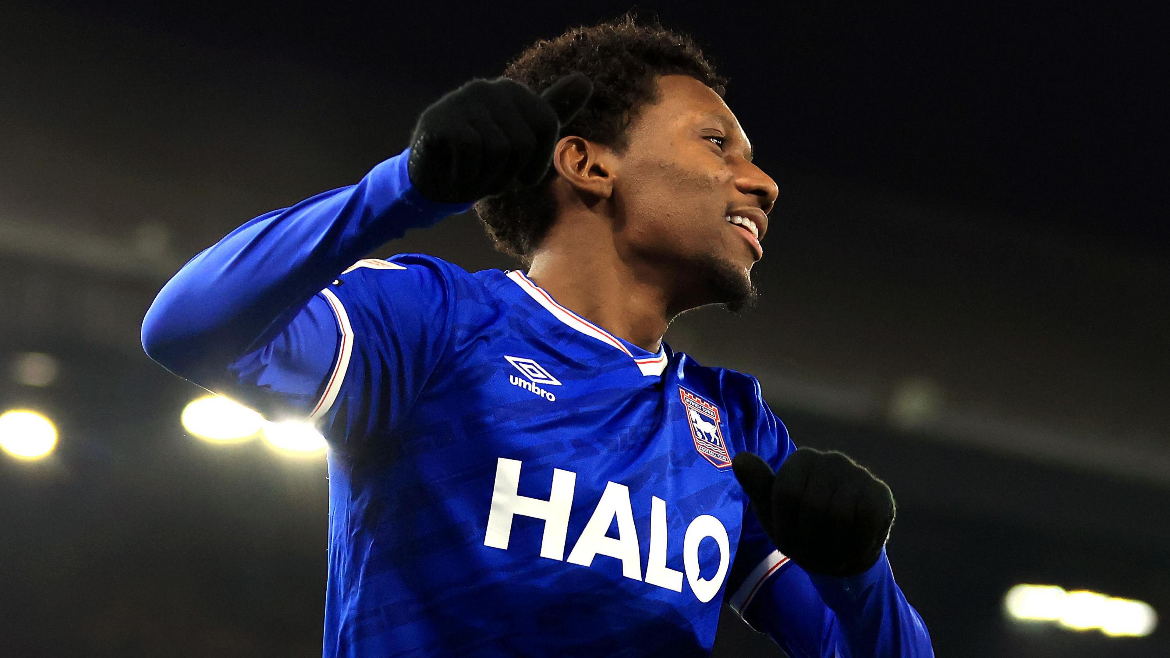 Jaden Philogene, wearing gloves, celebrates his goal for Ipswich Town against Stoke City