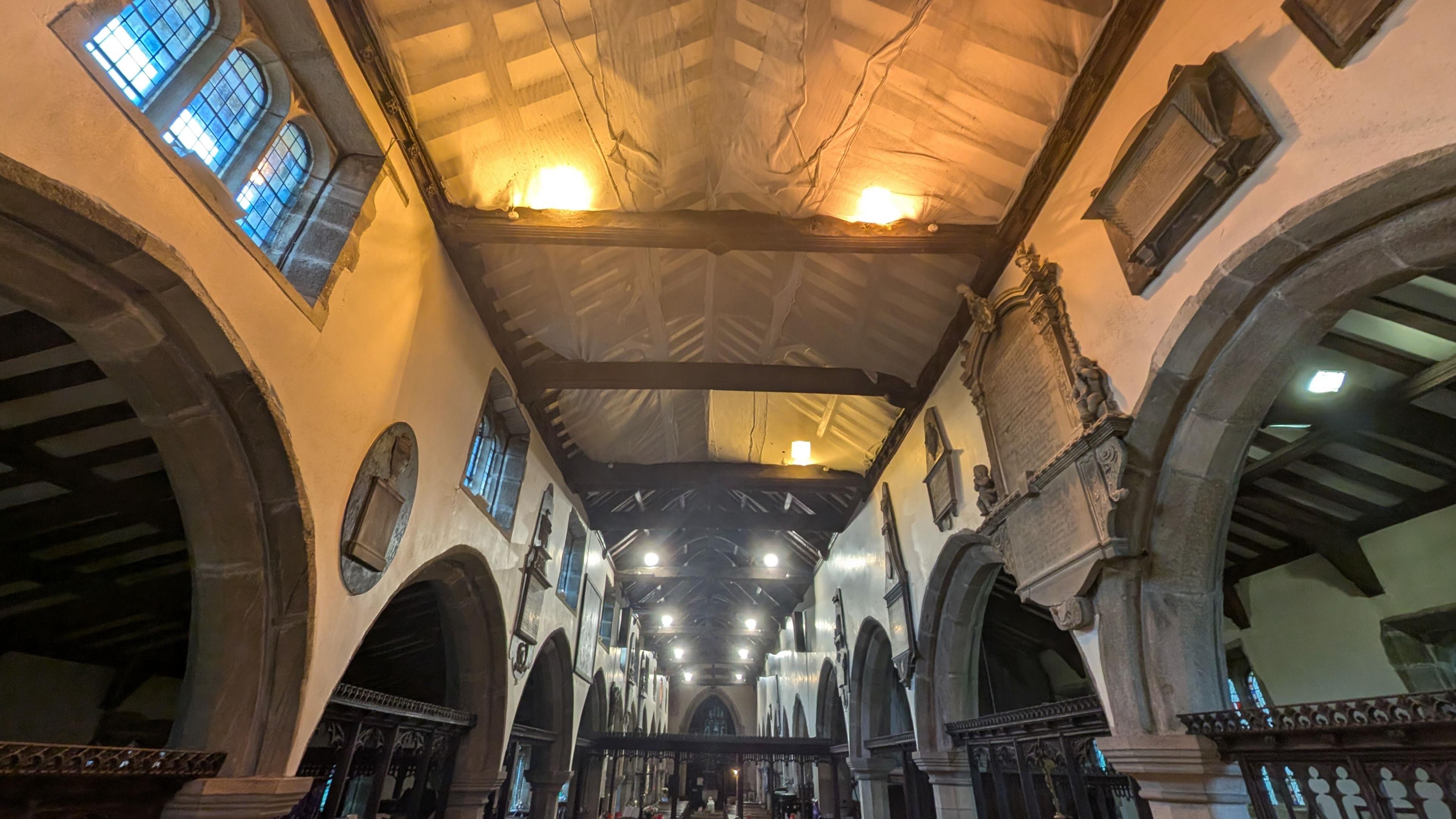 Inside St Andrew's Church netting has been installed beneath the roof to catch any falling masonry