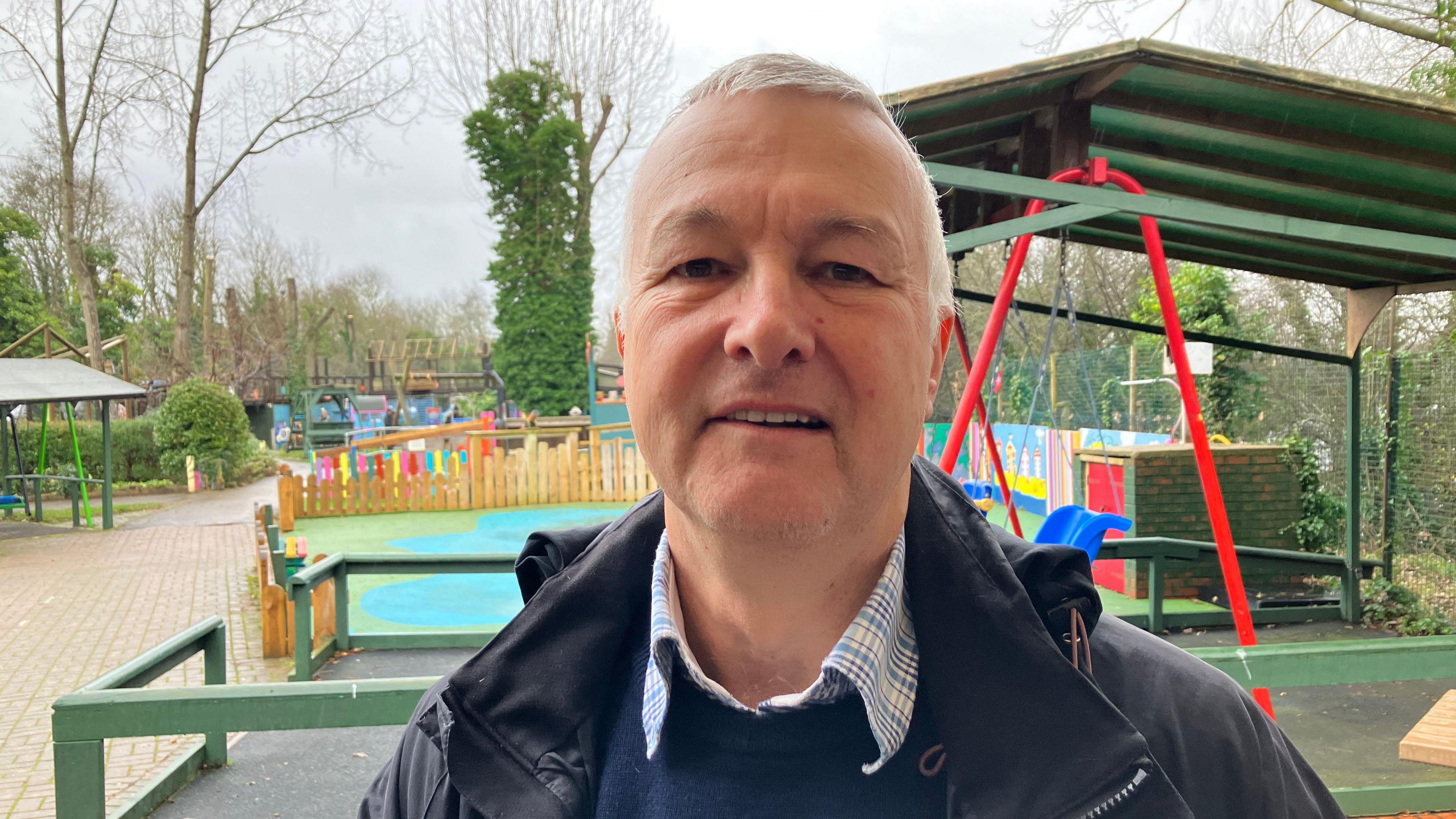 A picture of Jim Wilks, who is standing in front of part of the adventure playground.