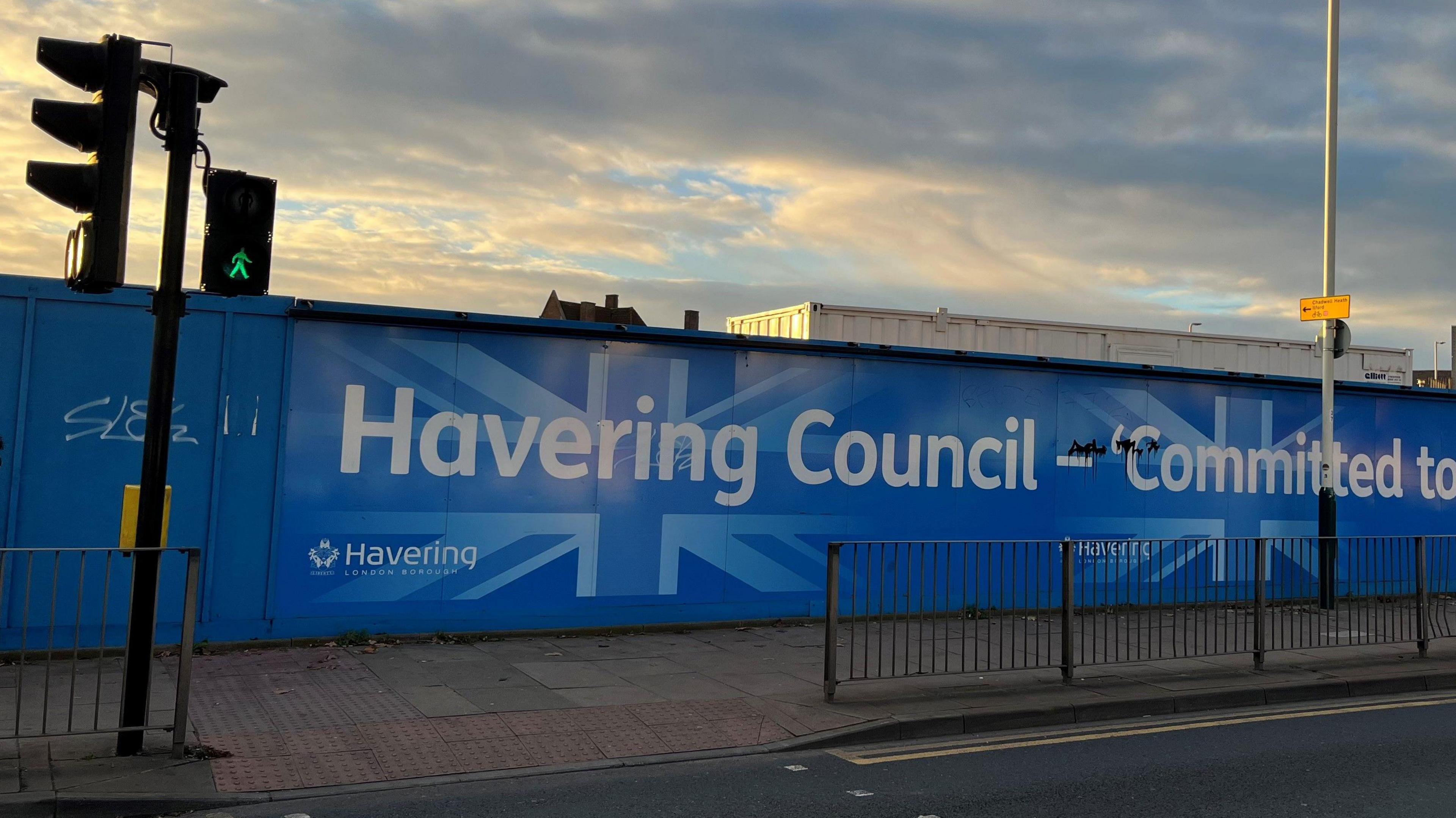 Blue hoarding around a building site in Romford with Havering Council logo on it