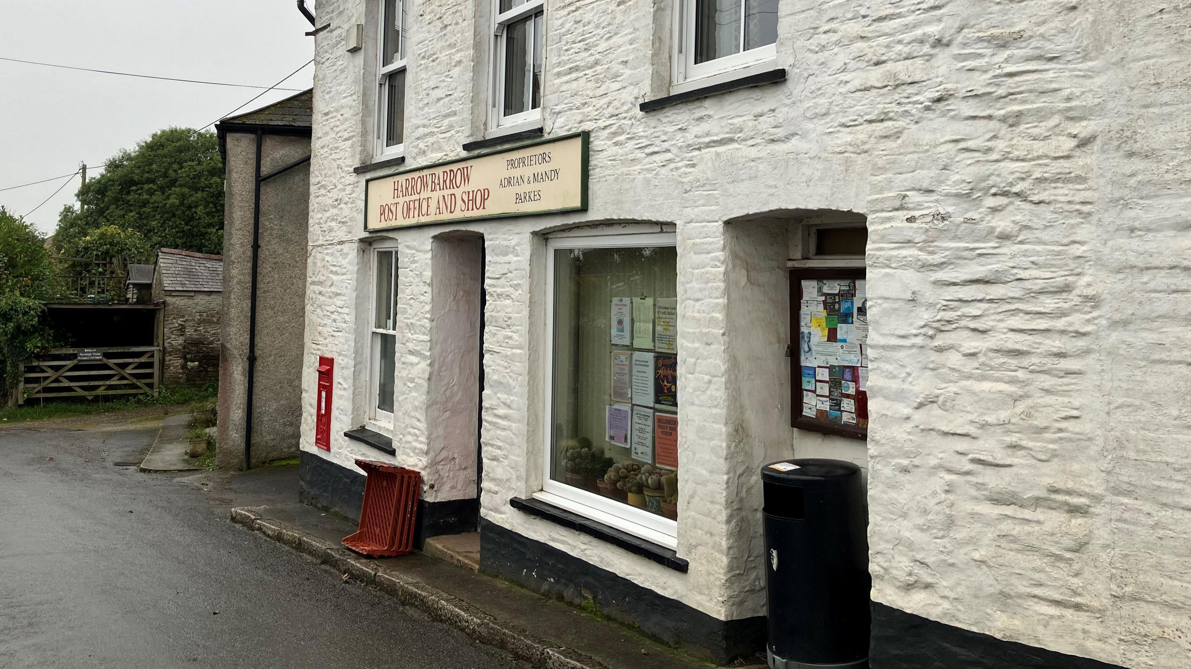 The village Post Office which is an old white brick building. 