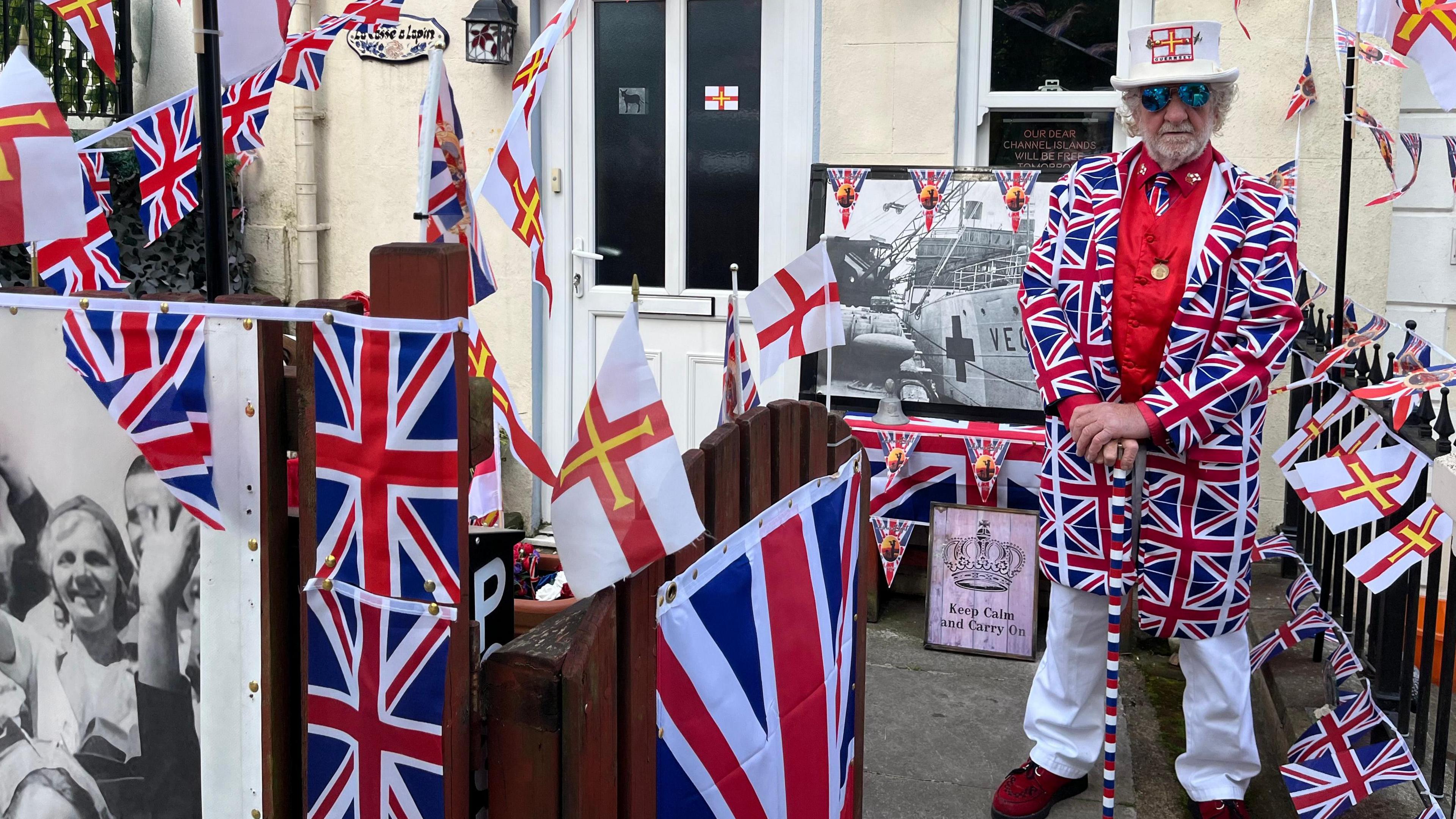 Close up of Geoff Le Gallez stood next to the flags