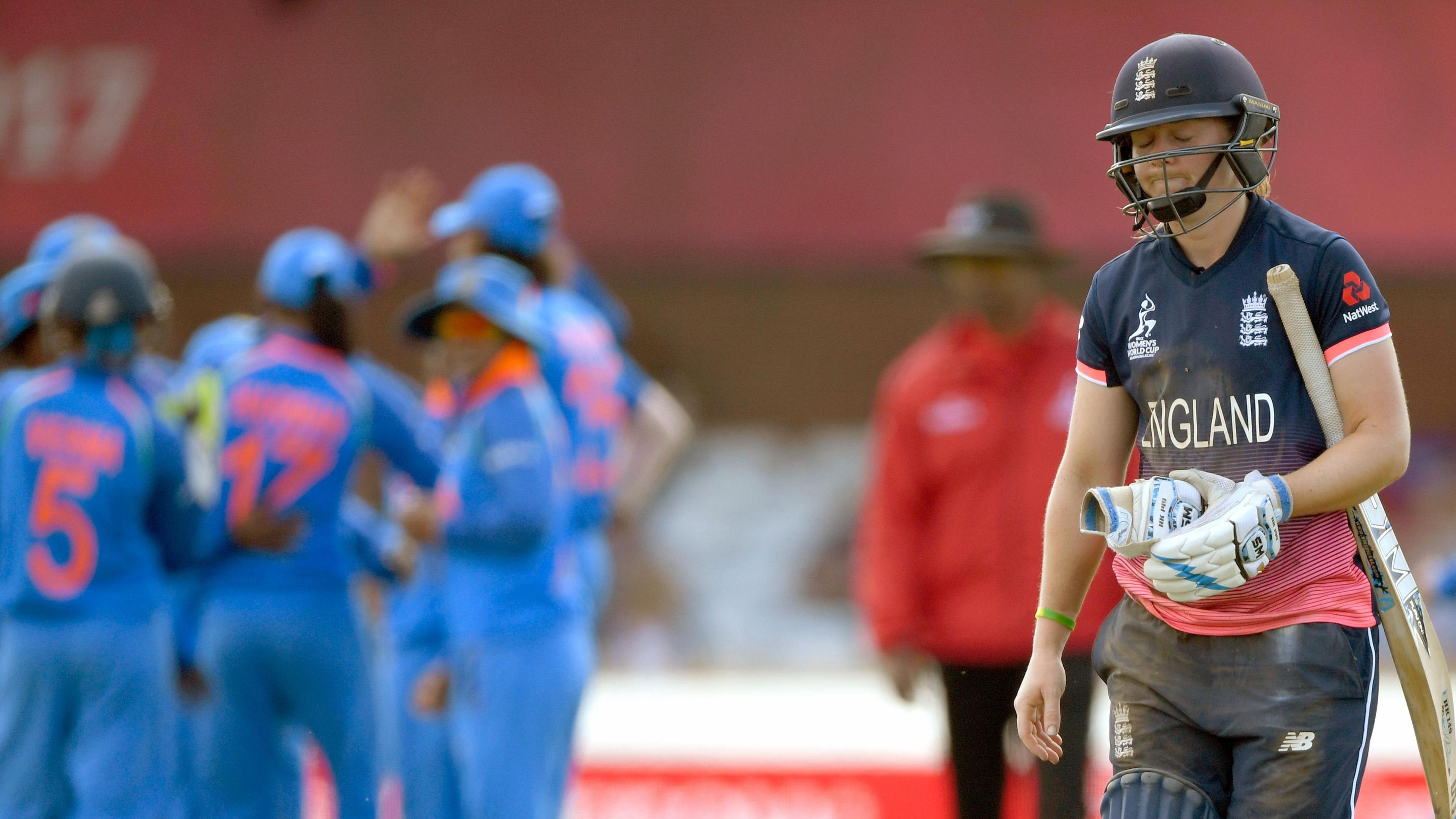 Heather Knight takes one glove off and looks despondent after her dismissal against India