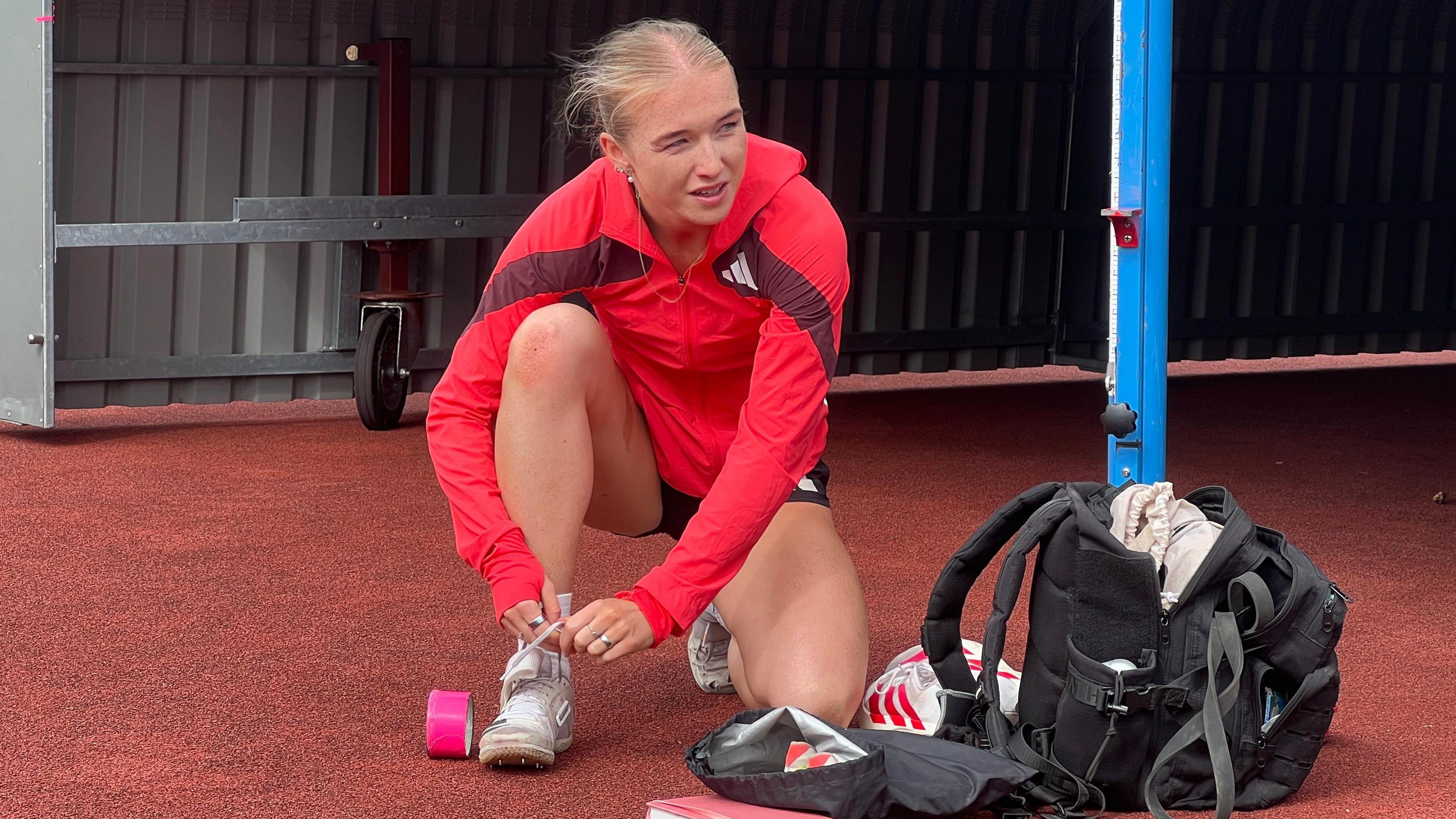Lucy Woodward ties her shoelace