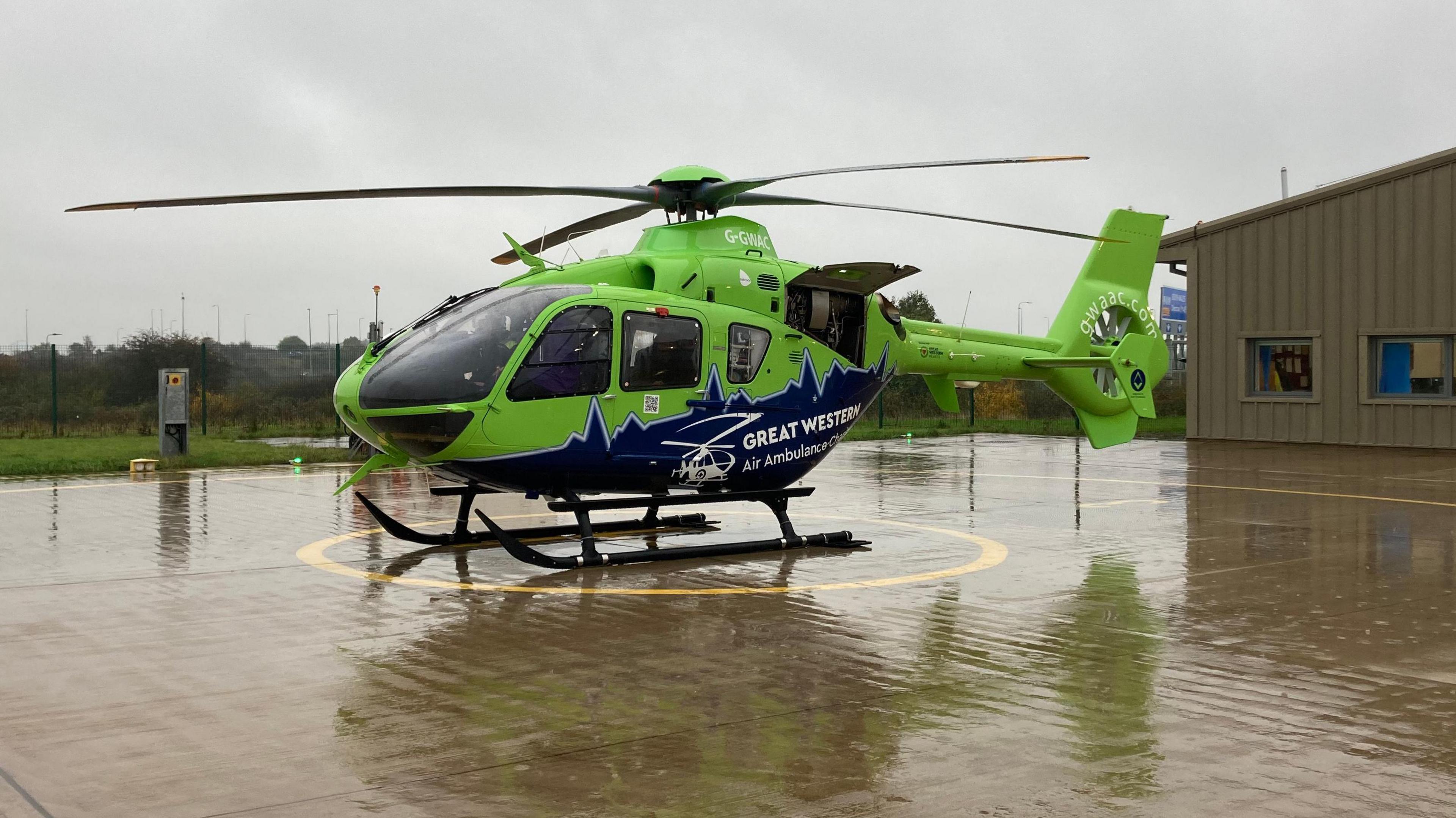 Green and blue Great Western Air Ambulance waiting for lift off 