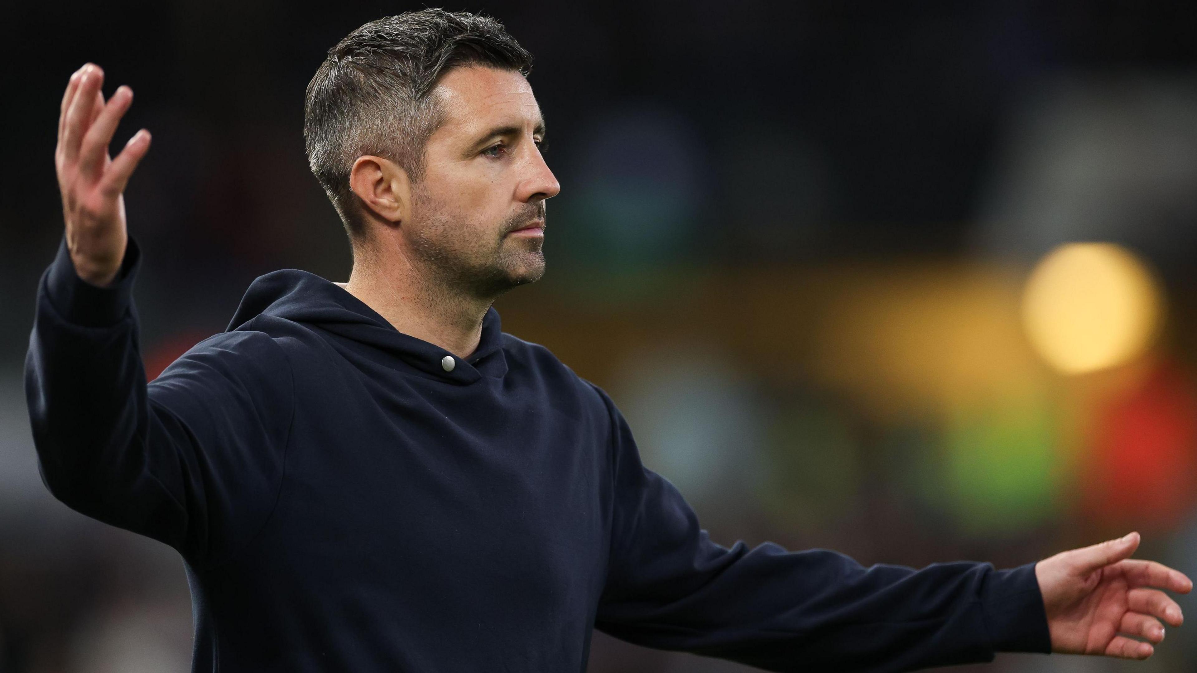 Alan Sheehan raises his hands on the touchline during Swansea's defeat to Ipswich  