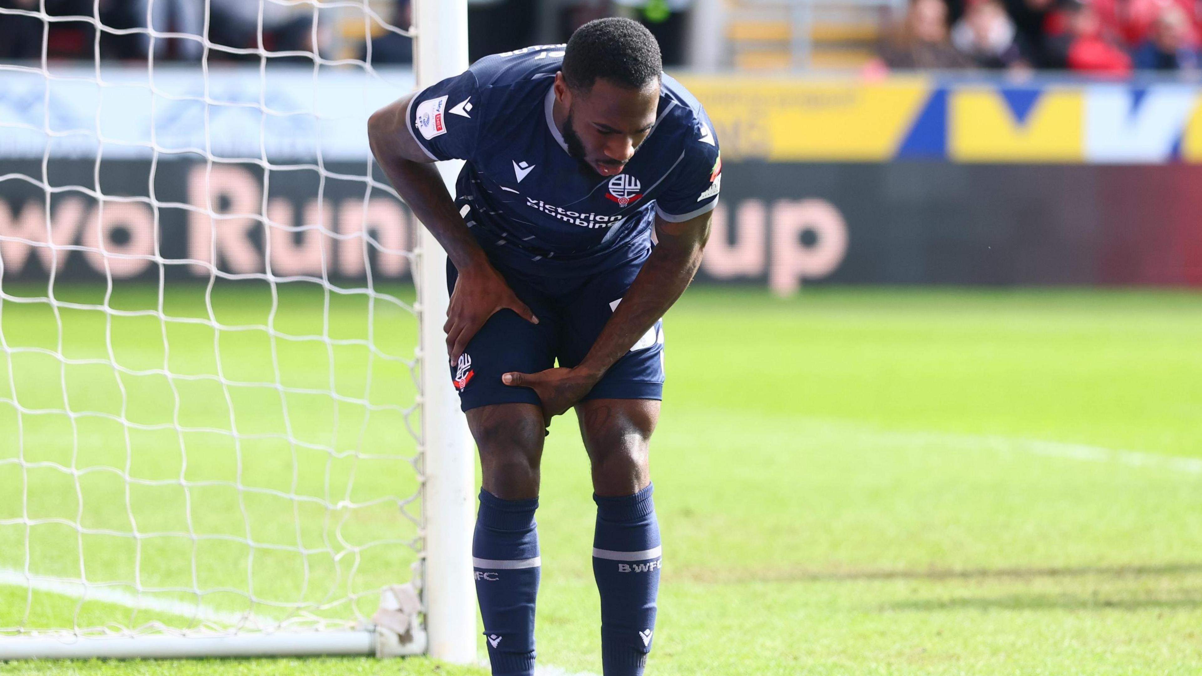 Corey Blackett-Taylor holds his right leg after taking a shot at goal.