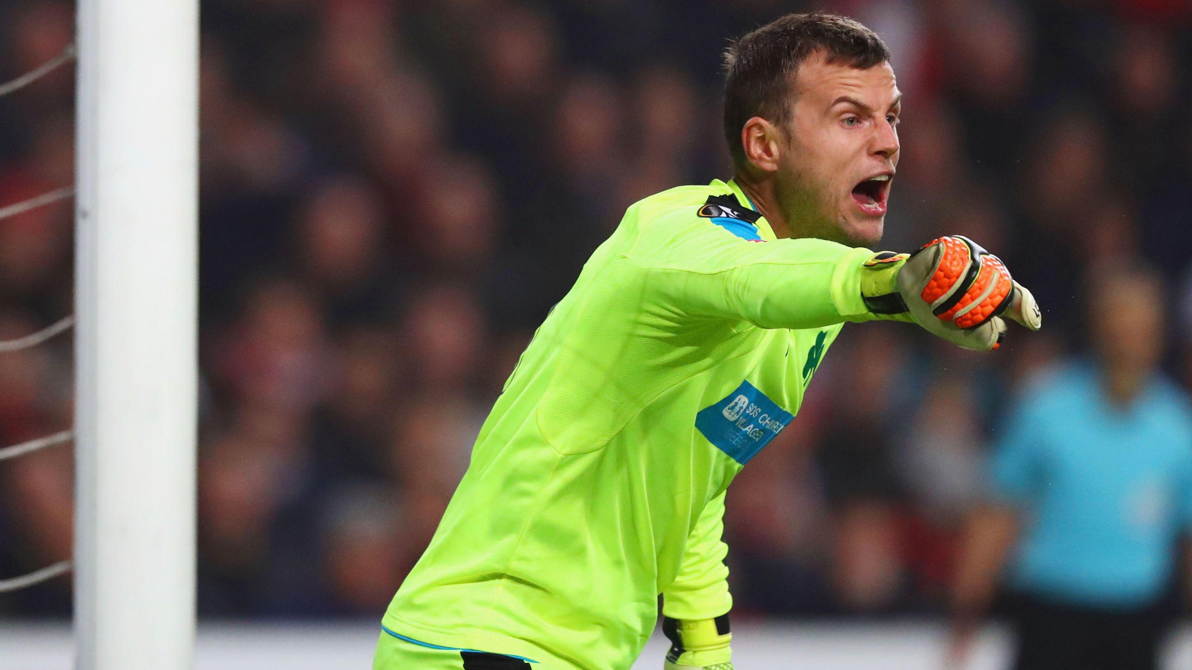 Luke Steele, with arm outstretched, playing for Panathinaikos
