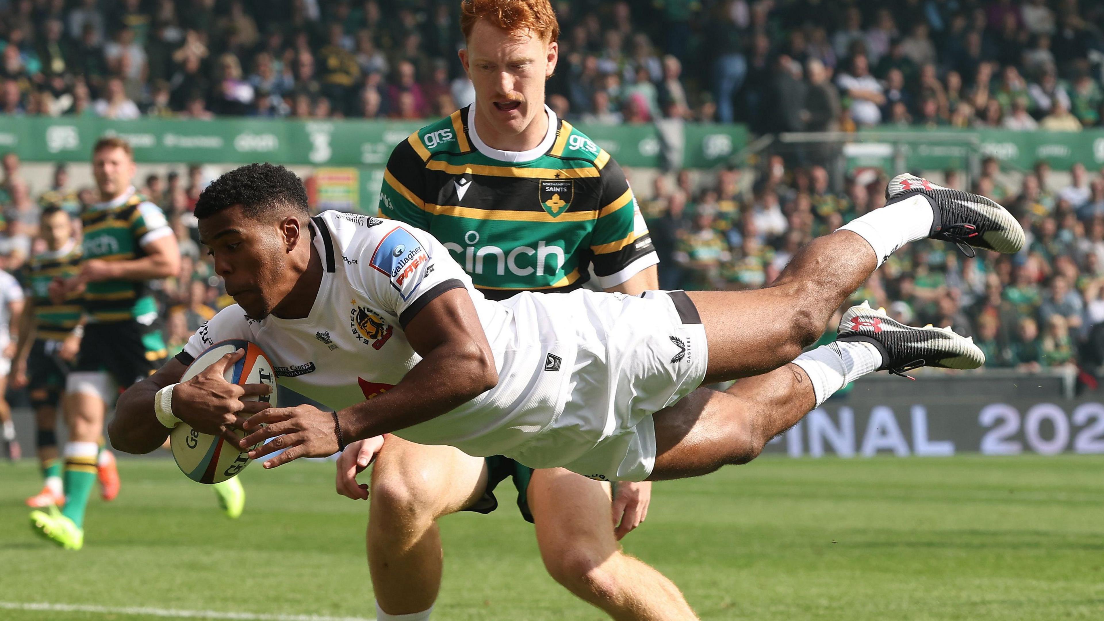 Immanuel Feyi-Waboso dives over for a try at Northampton