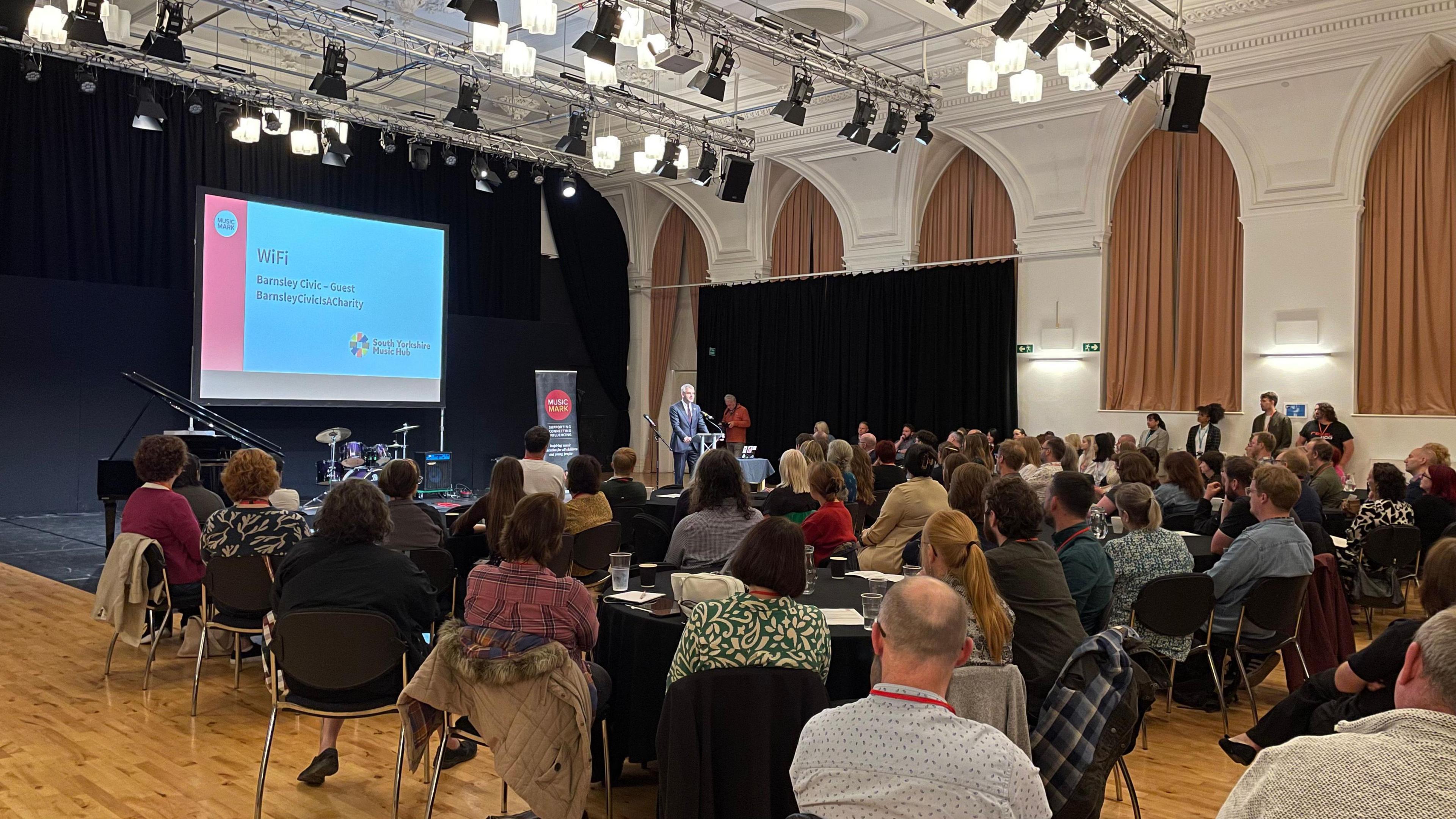 People gather in a hall to watch a power point display at the launch of the music hub in Barnsley