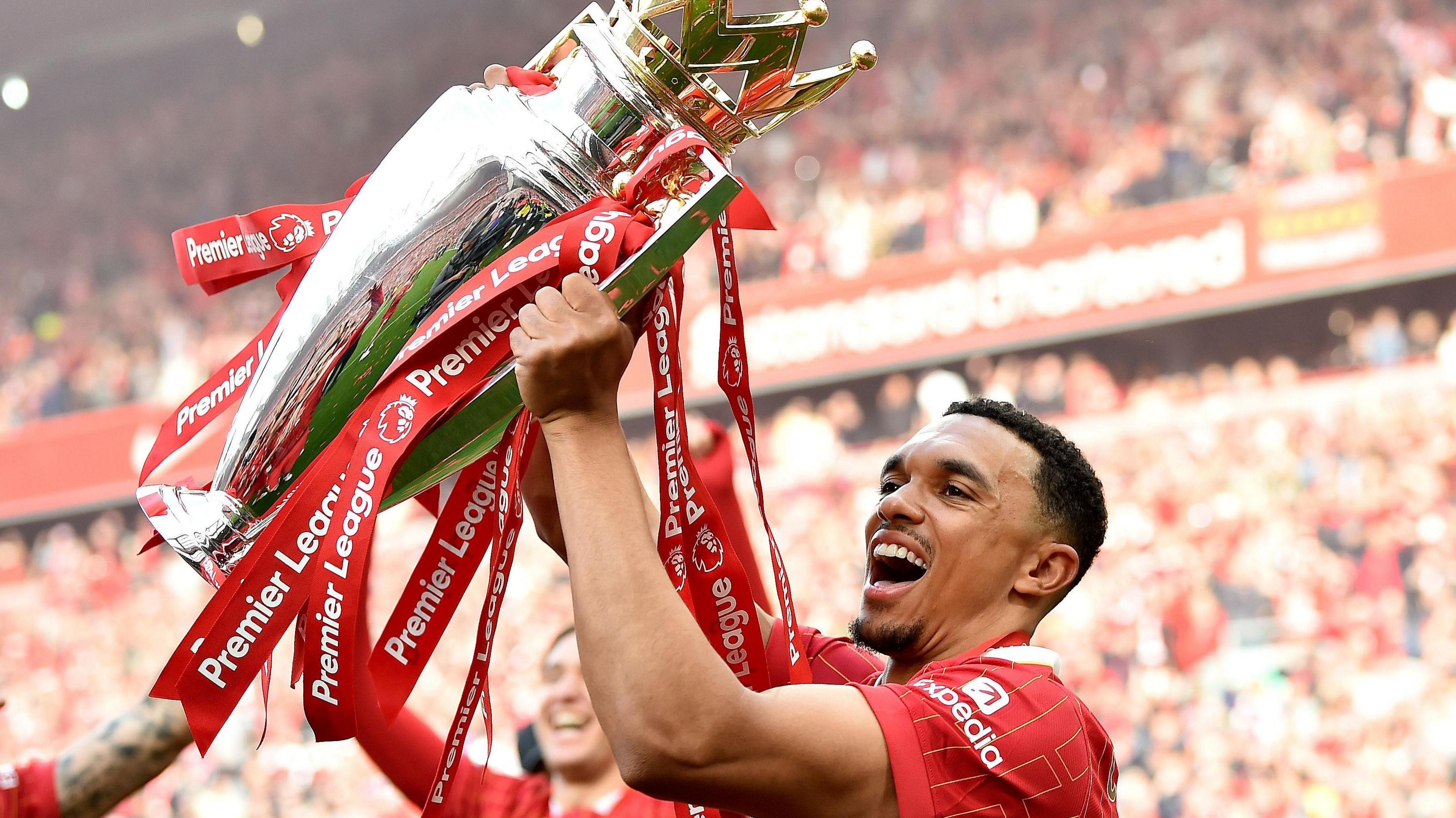 Trent Alexander-Arnold of Liverpool holds up the Premier League trophy