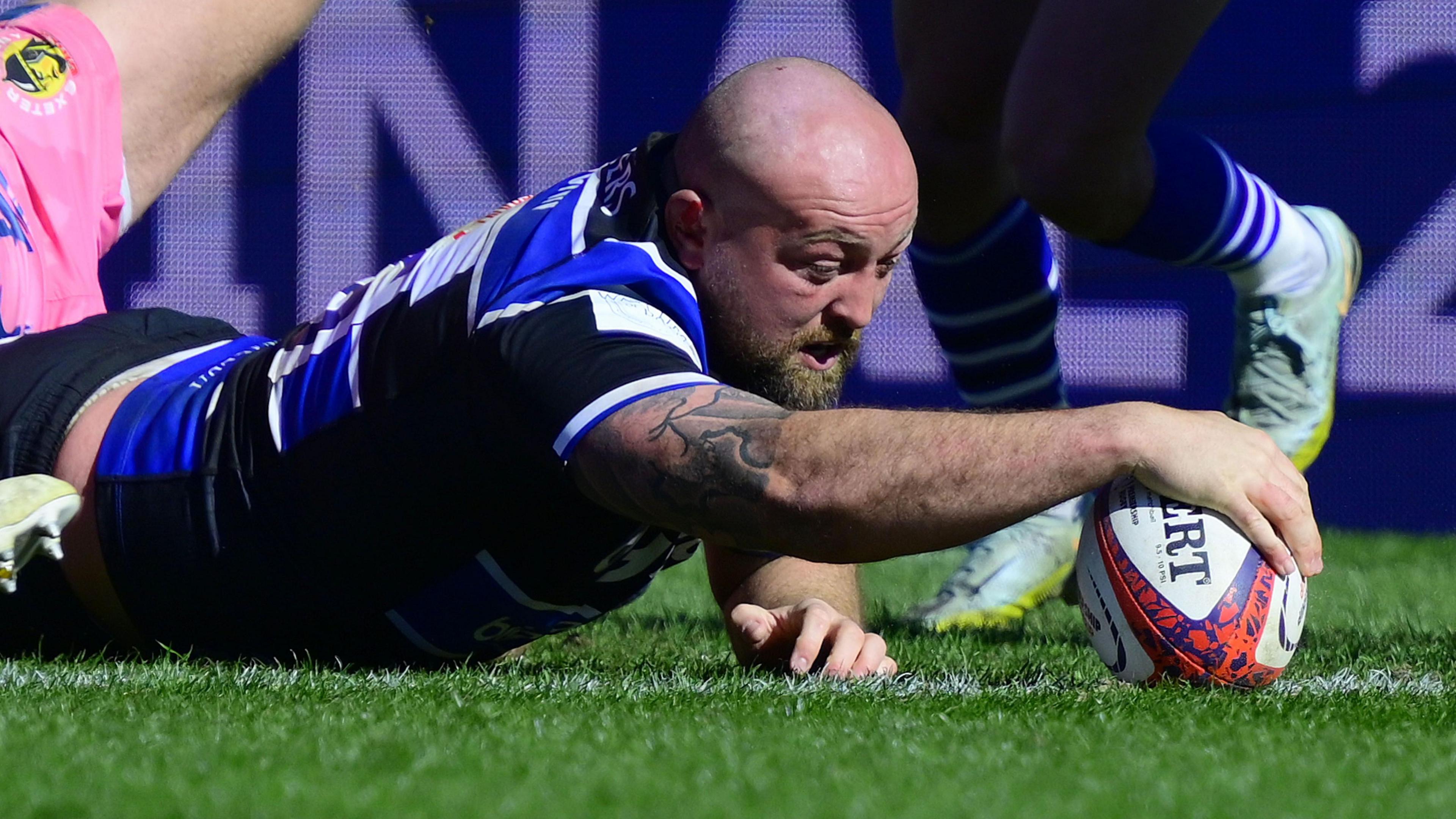 Tom Dunn stretches over for the first of two tries in the Premiership Rugby Cup final