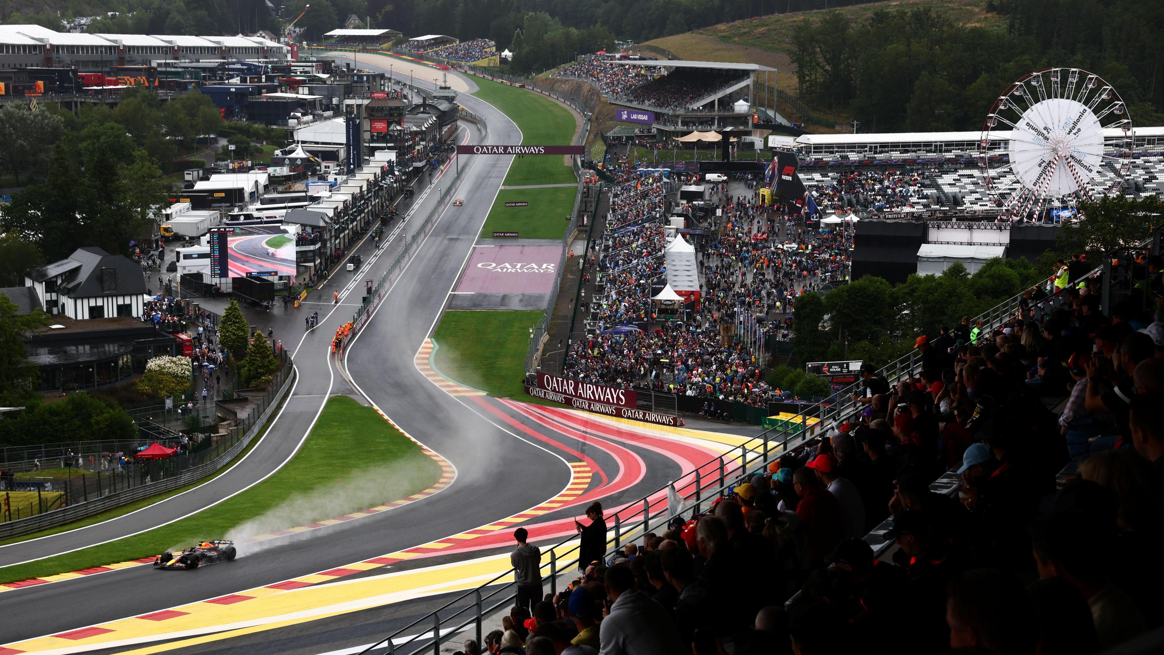 Red Bull's Max Verstappen drives his Red Bull up the Eau Rouge corner in wet conditions during practice for the 2024 Belgian Grand Prix
