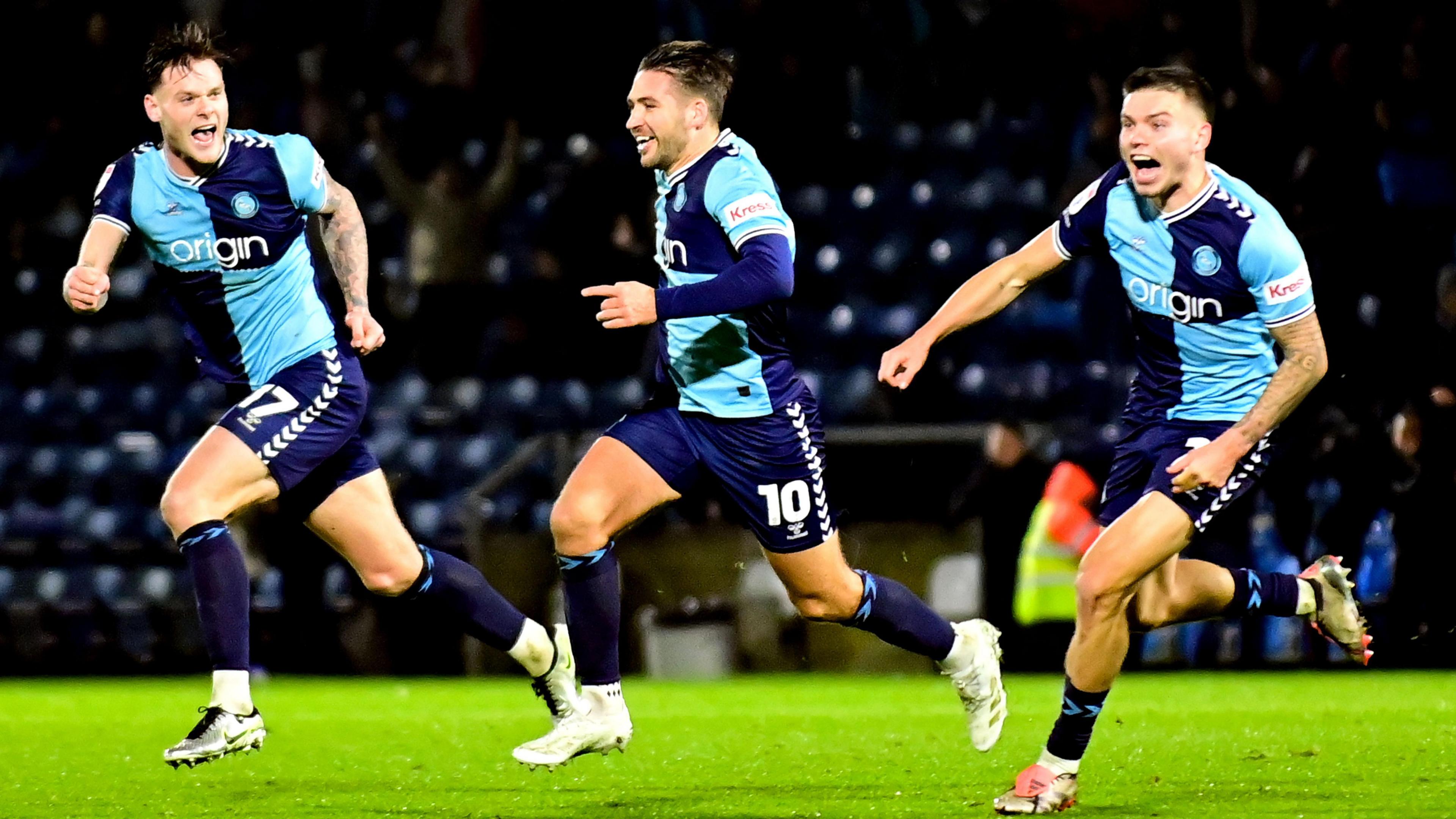 Luke Leahy runs up the pitch, celebrating his winning goal with fellow Wycombe players