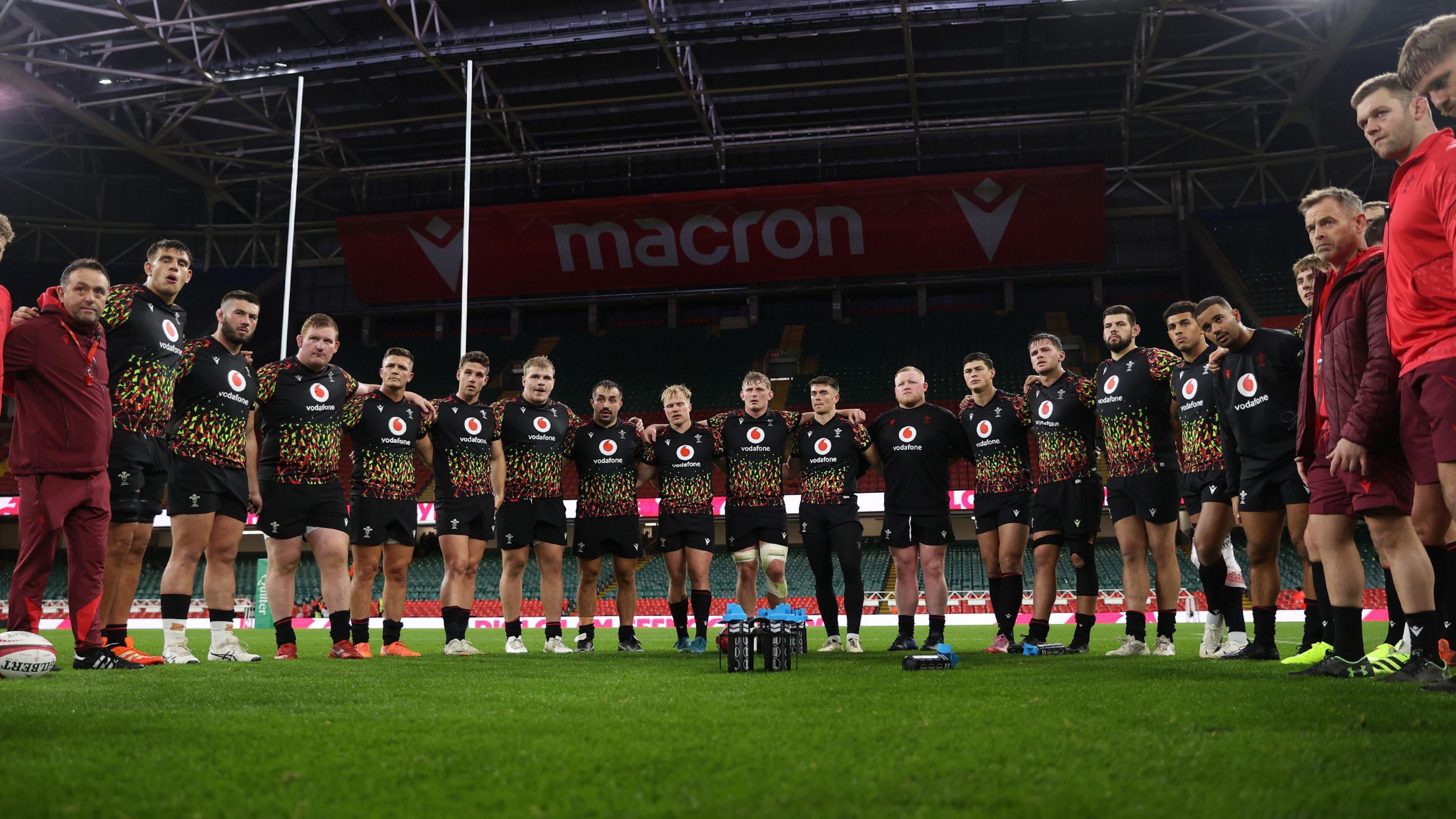 Wales team in a huddle at a training session