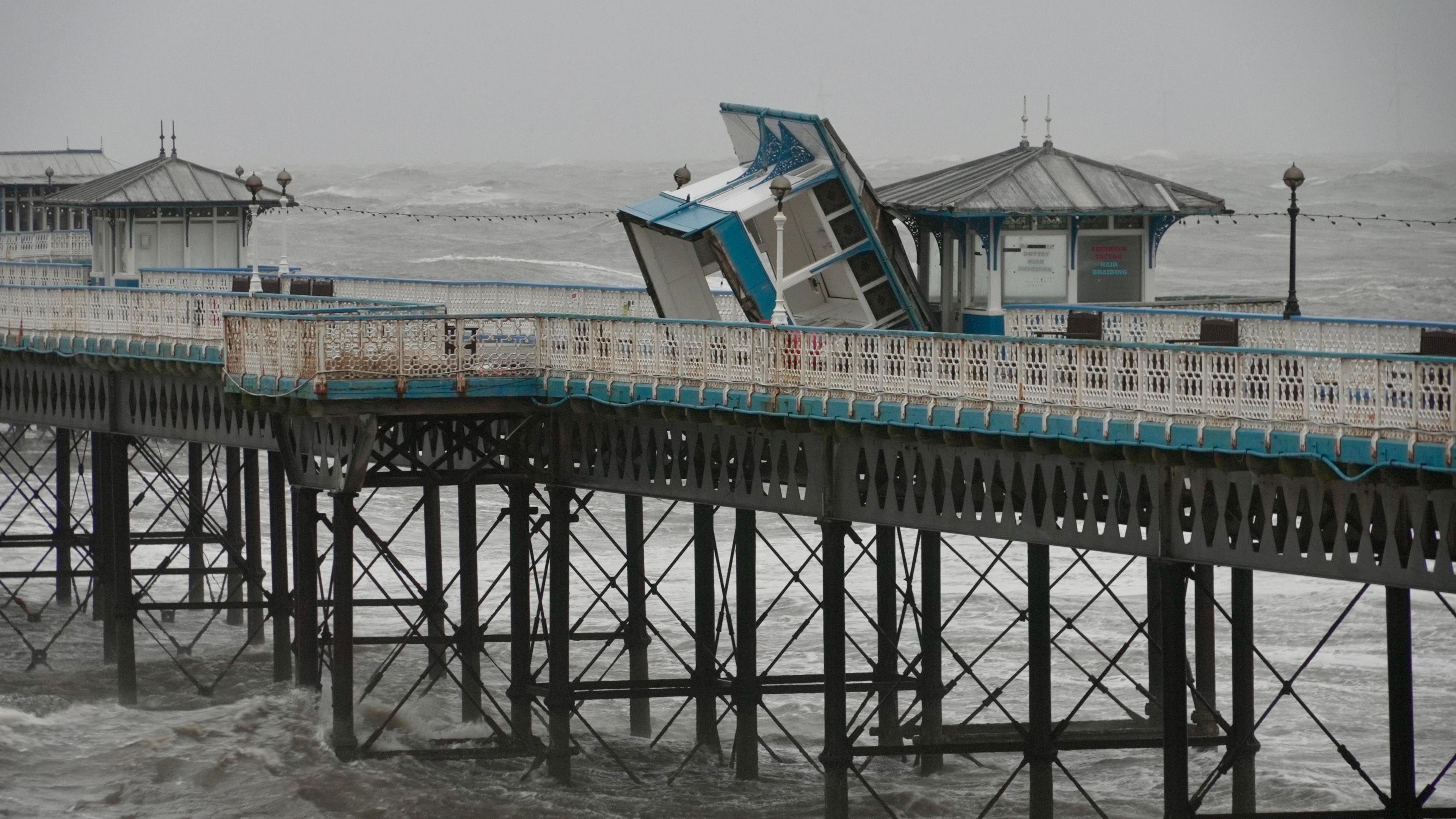 A pier kiosk torn from foundations and blown away