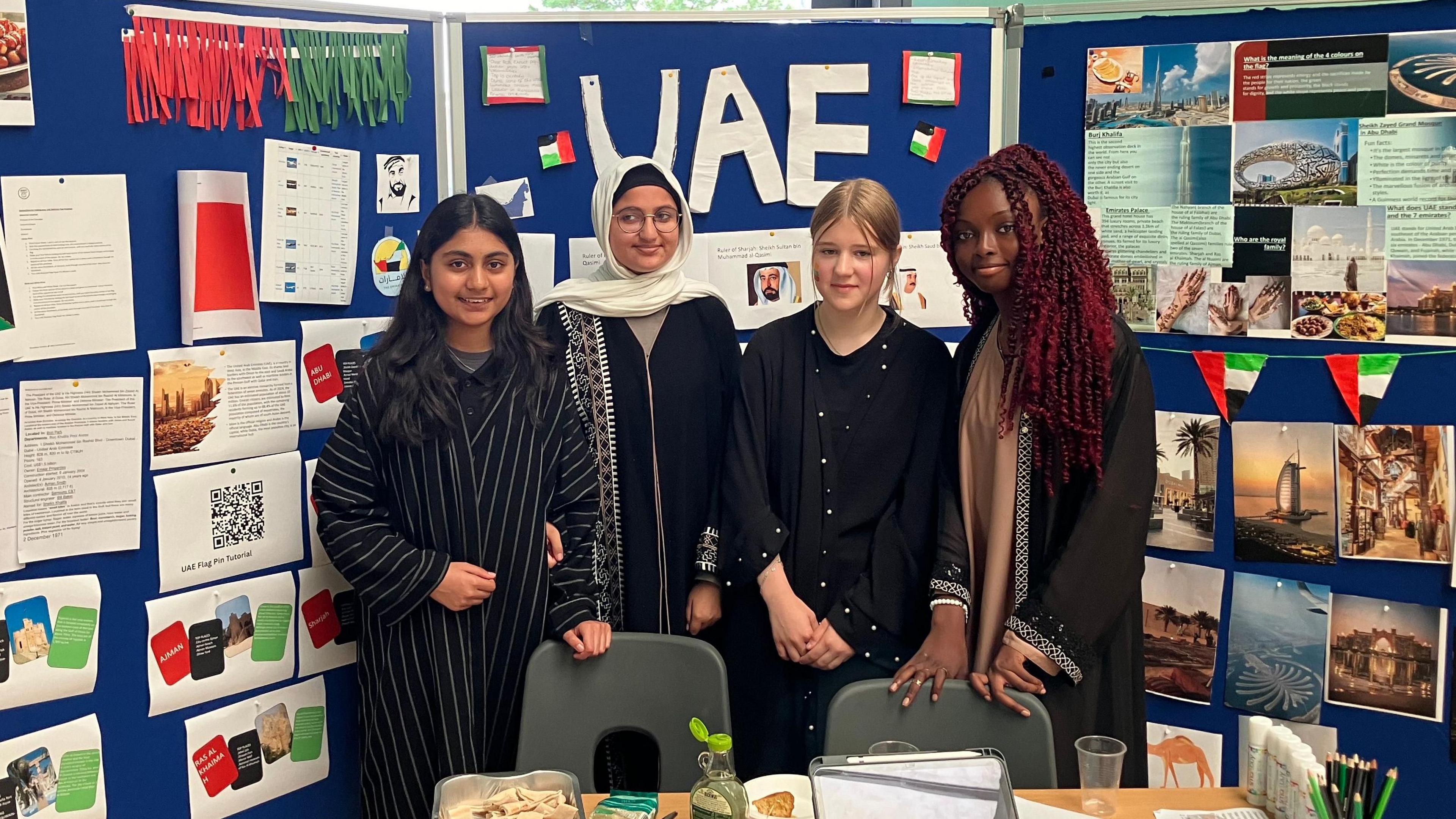 Yusra, Haleema, Goda and Kyla dressed in black abayas 