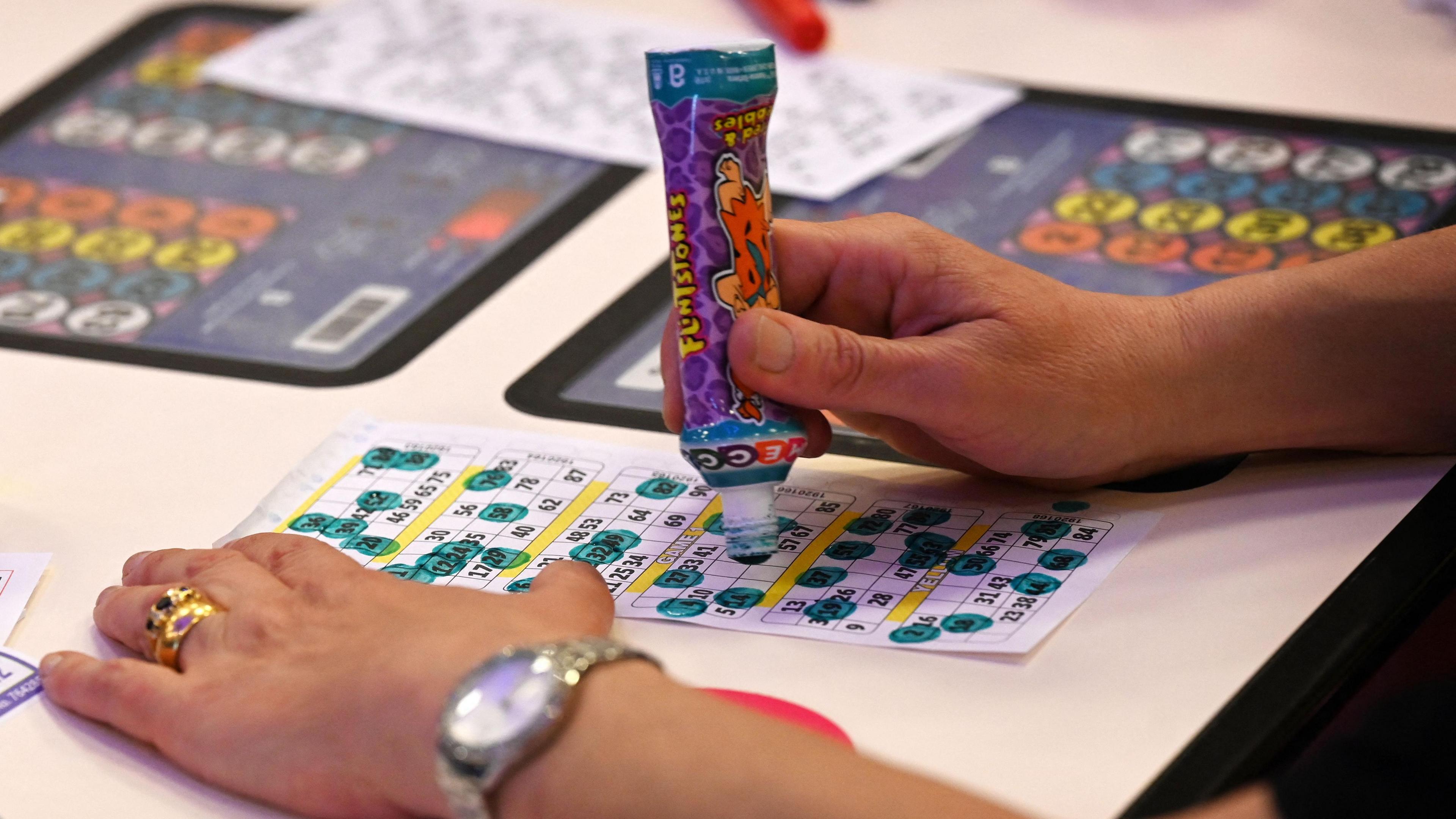 A close-up photo of a person playing bingo.