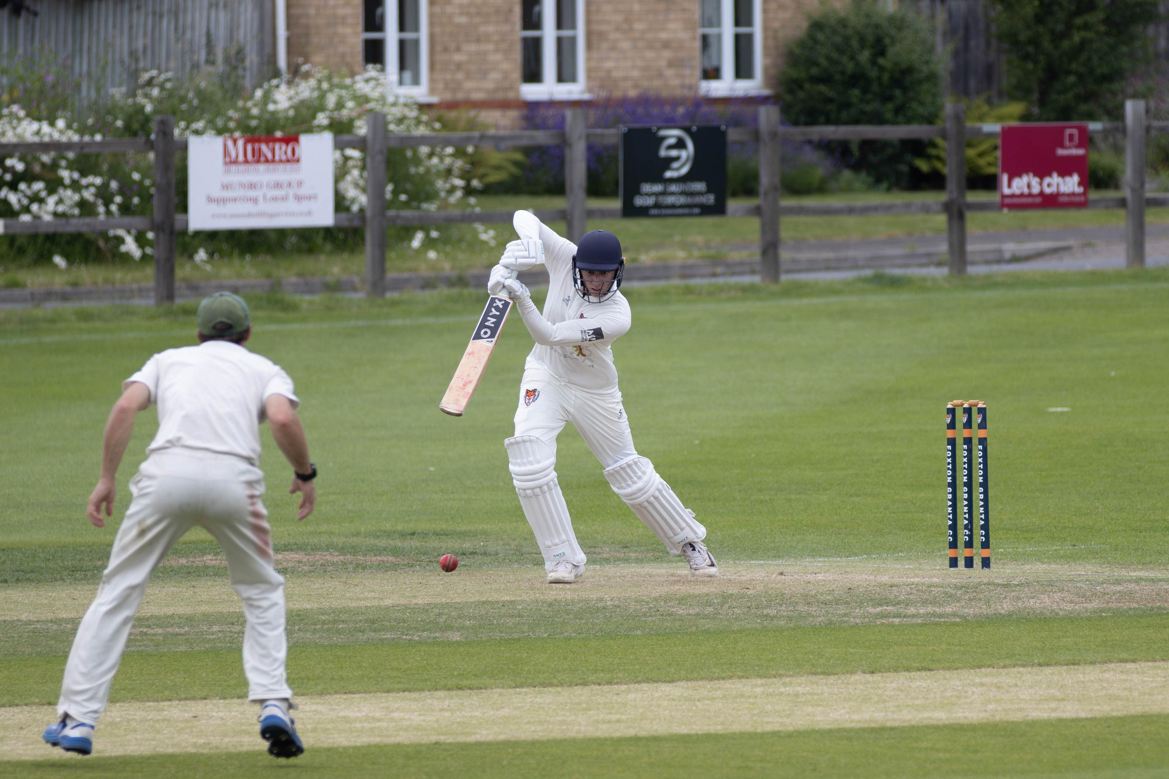 A left-handed batsman hitting a ball towards an offside fielder.