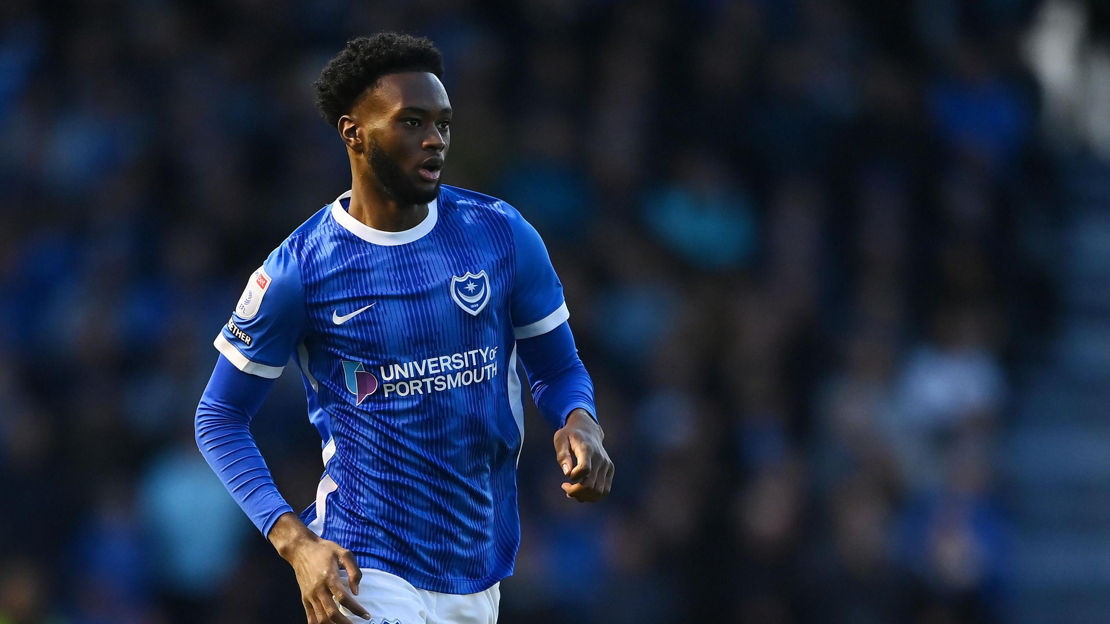 Abu Kamara playing for Portsmouth in their blue home kit in April 2024