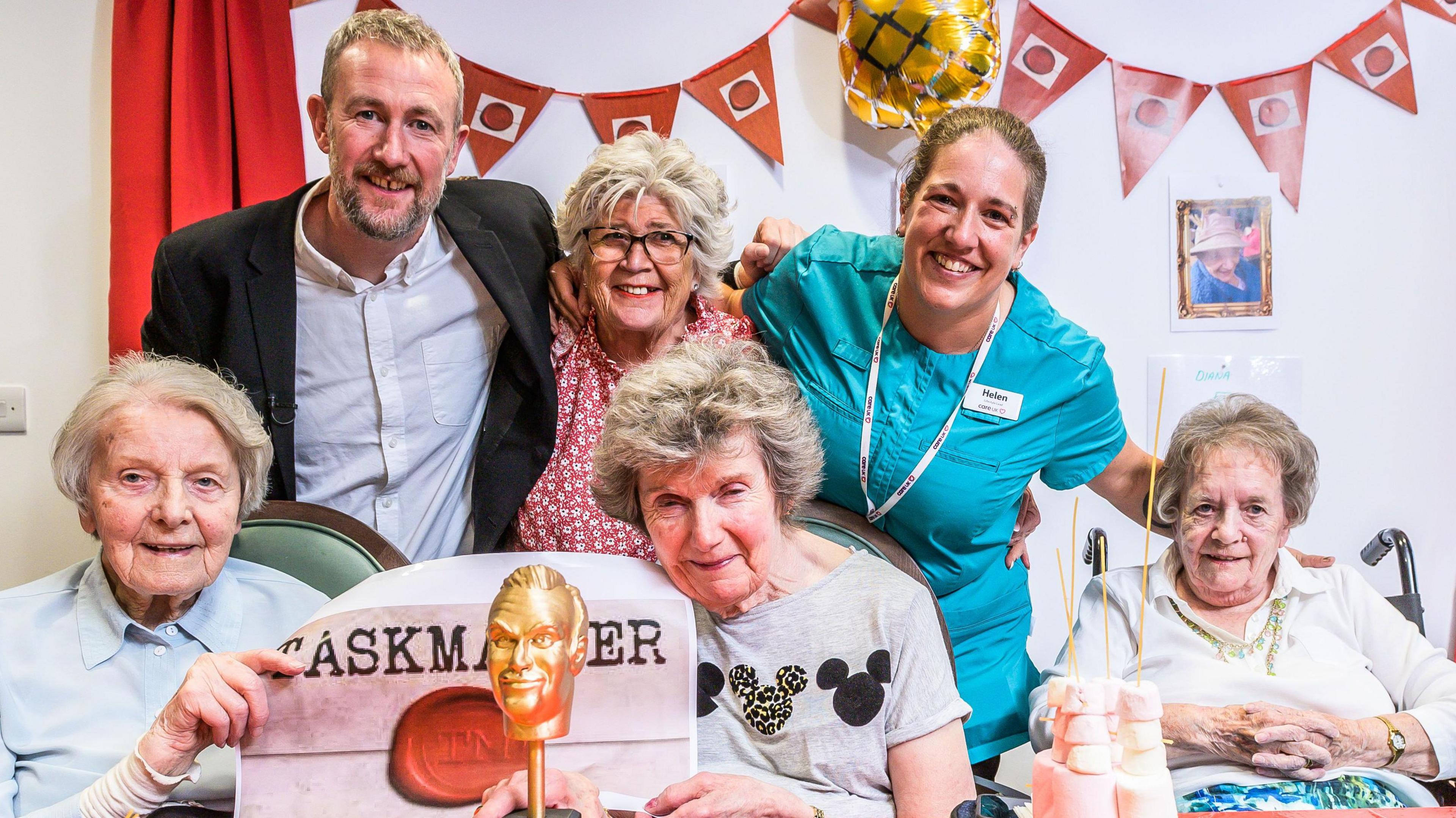 Taskmaster host Alex Horne with (back row left to right) Linda and CareUK Lifestyle Lead Helen (front row left to right) residents Ruth, Chrissie and Diana, at Seccombe Court care home in Adderbury.