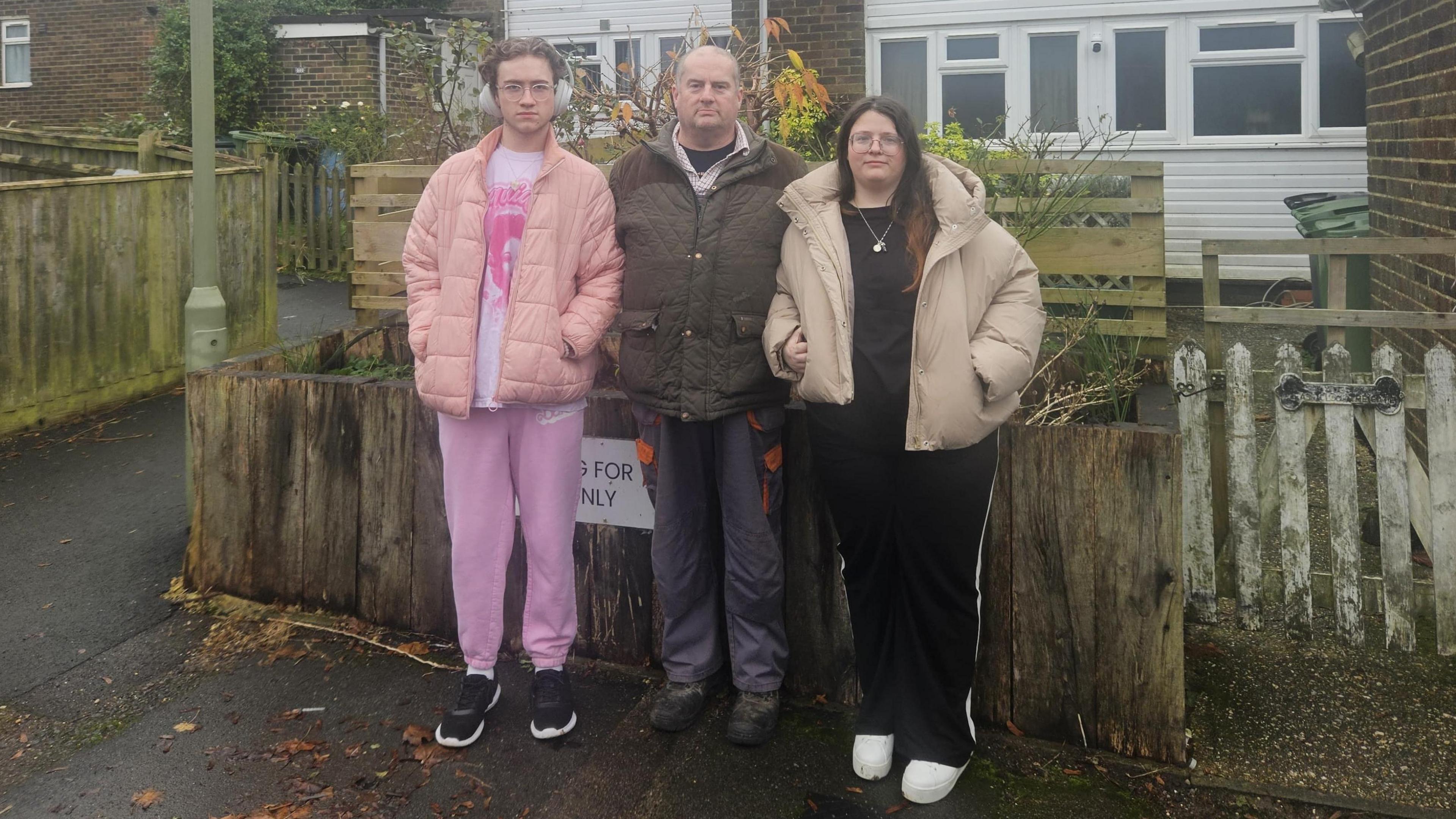 Jason Ebury stood alongside his kids outside their home