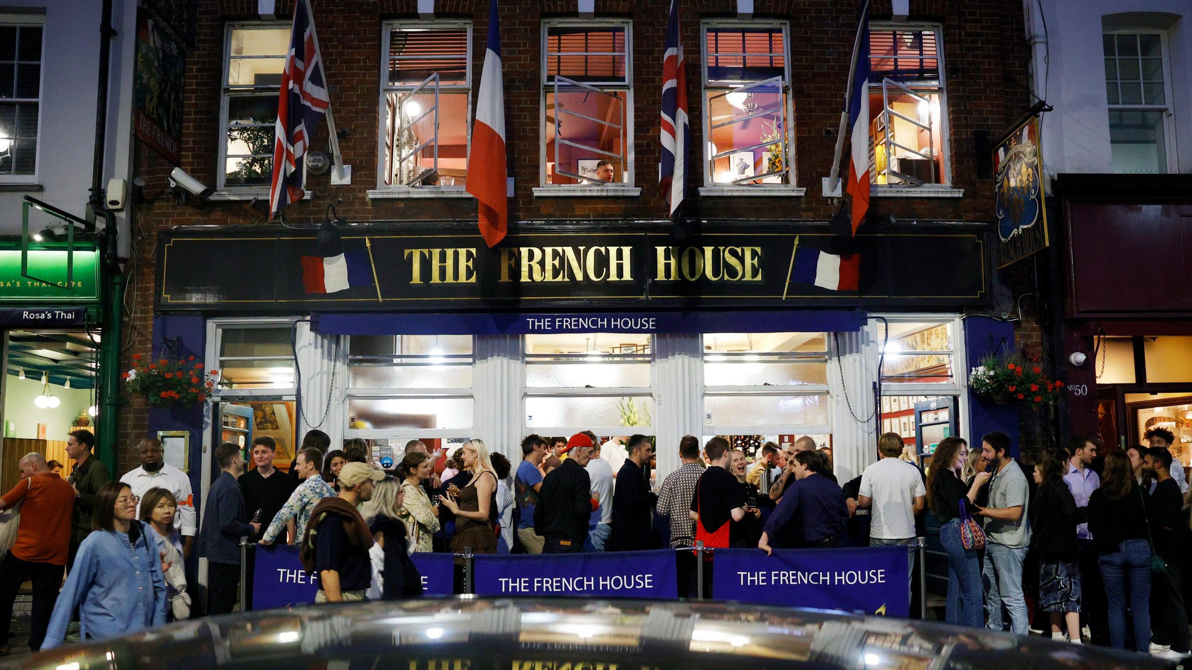 Revellers outside a central London pub called the French House