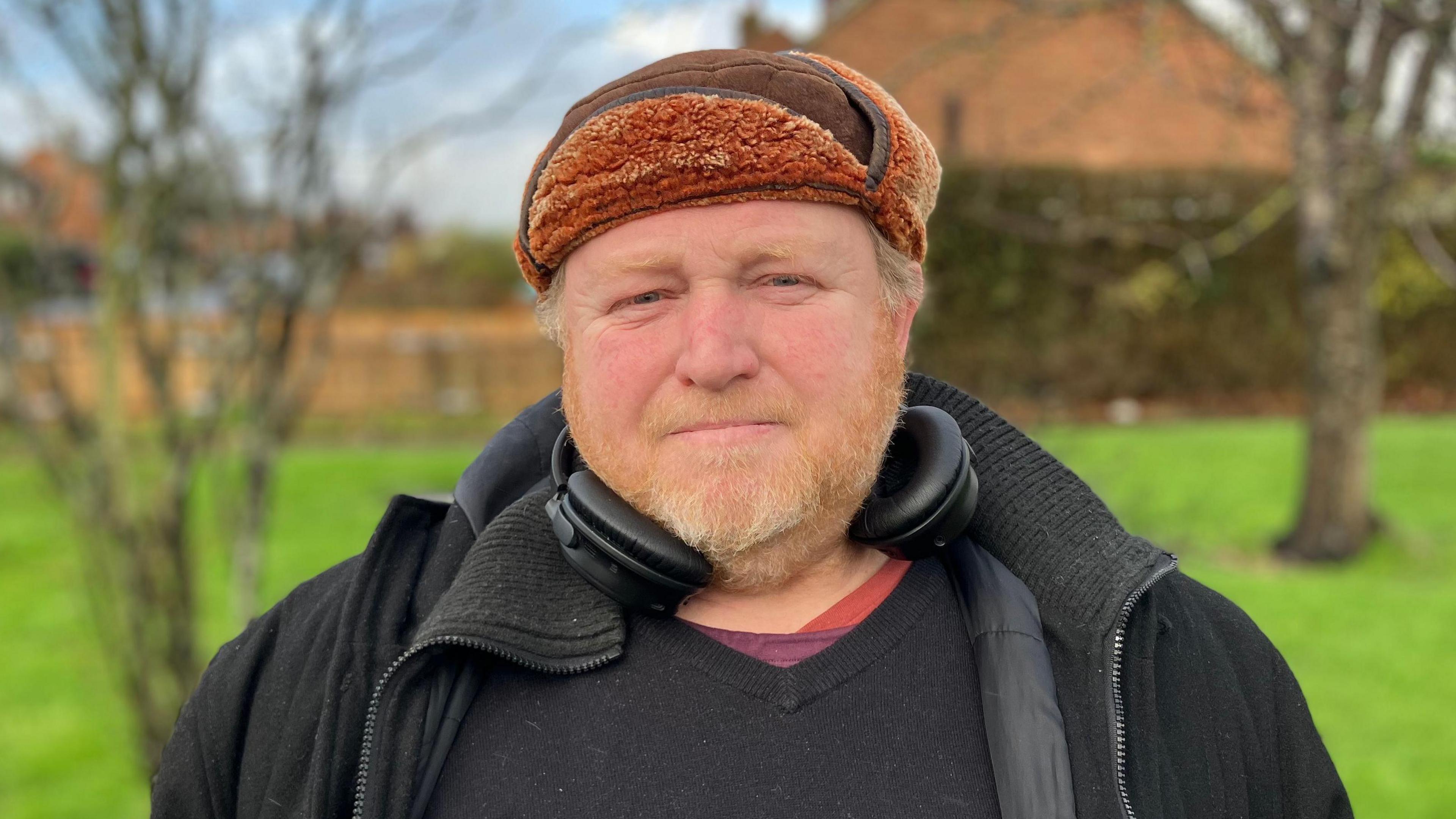 Herne Bay resident Matt Barnard stood in front of grass and trees. He is wearing a hat and looking directly at the camera. 