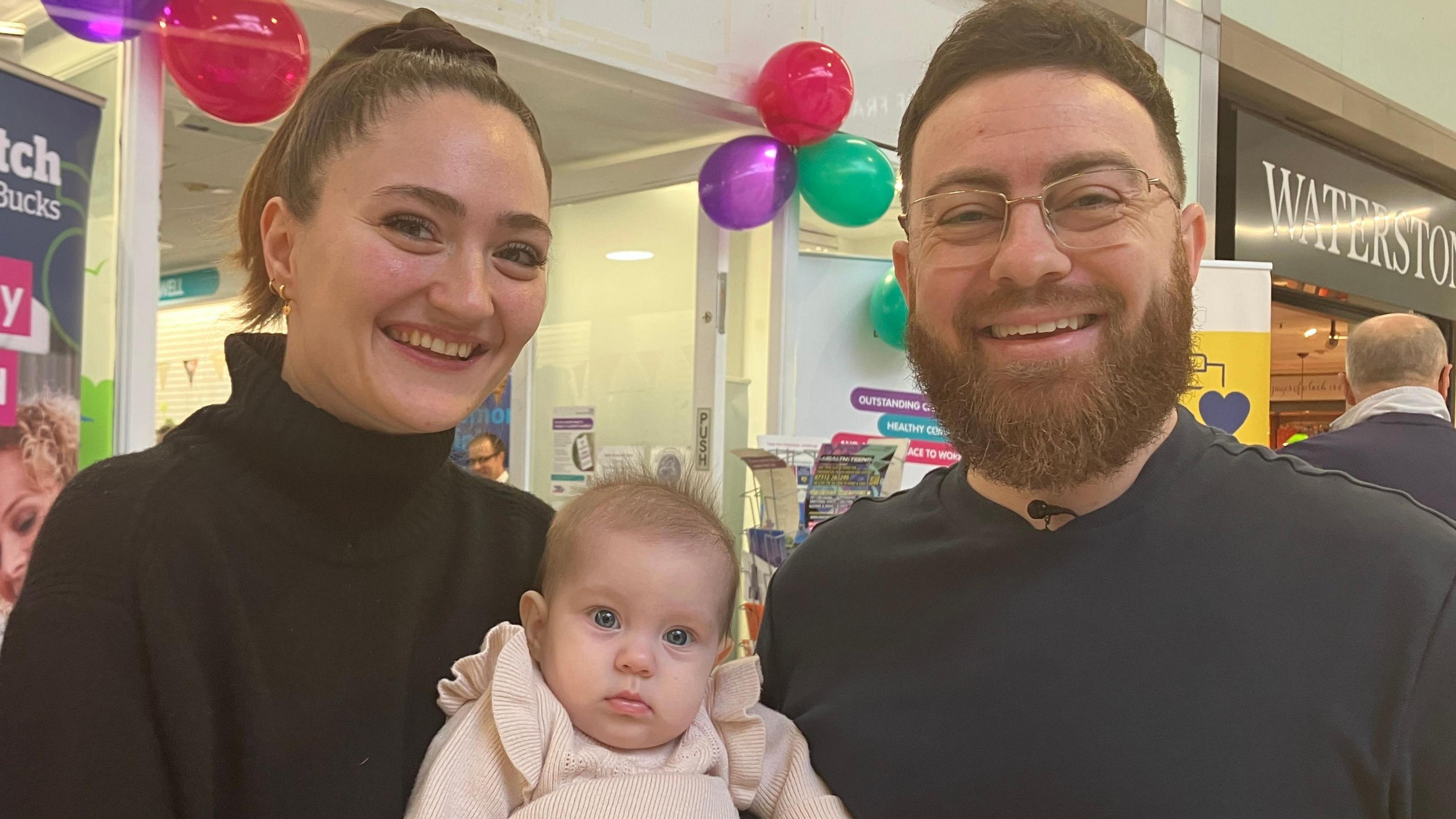 Jade and her partner Matt and their daughter Adeline. The picture has been taken while the family was visiting Unit 33 a health hub in a shopping centre.