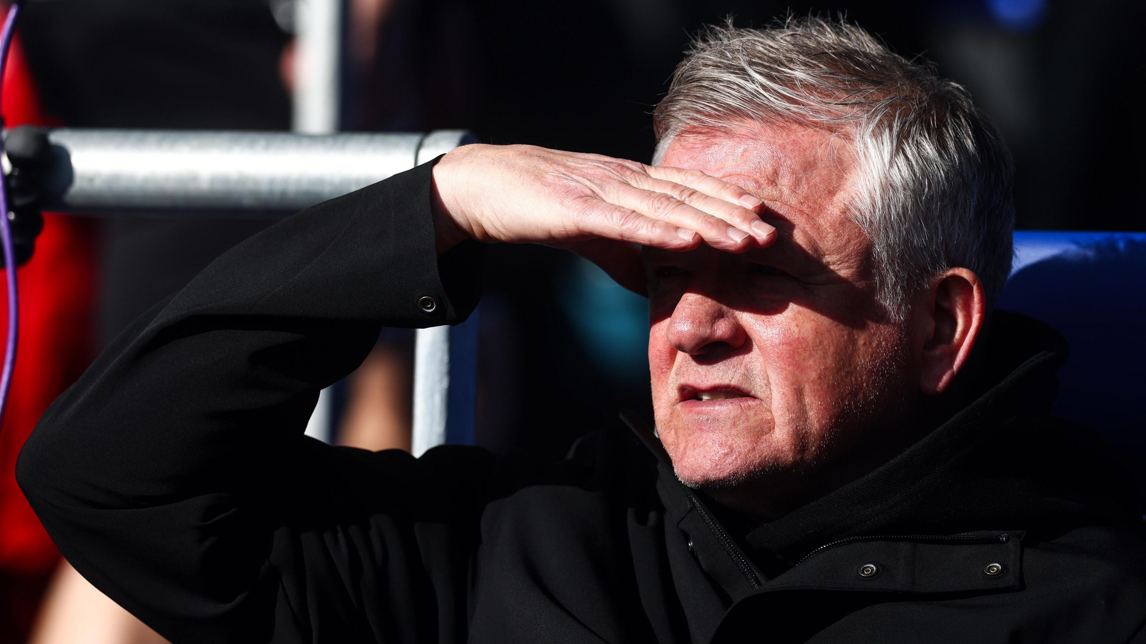 Chris Wilder shields his eyes from the sun