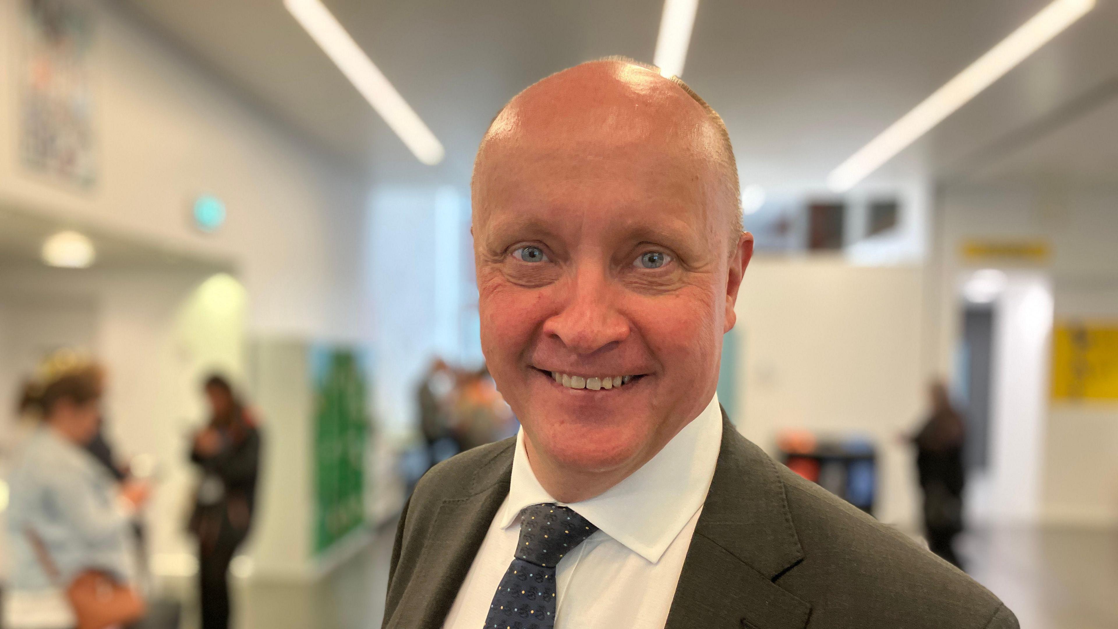 Finland's ambassador to the UK Jukka Siukosaari smiles for the camera wearing suit