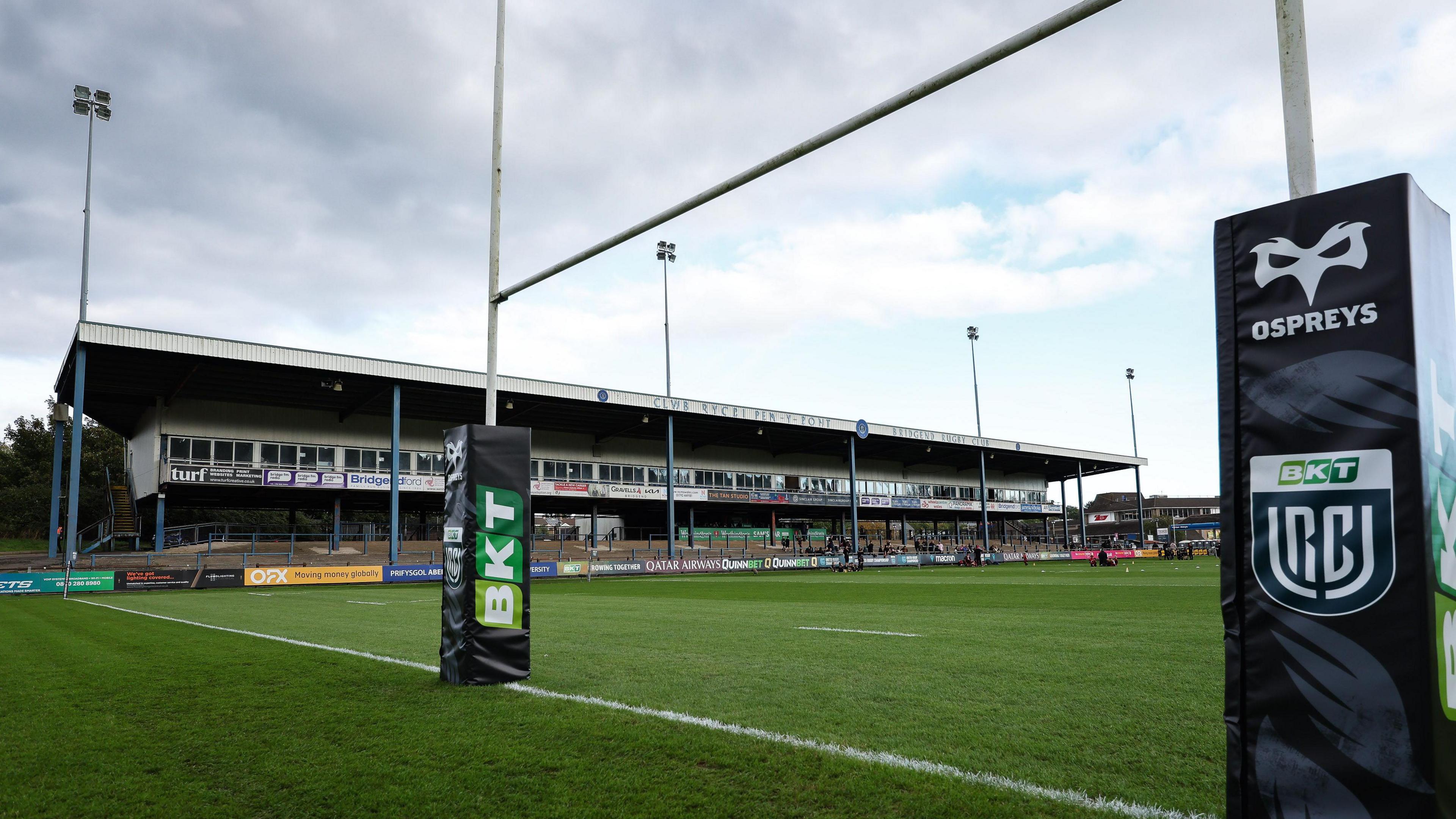 Ospreys branding on rugby posts in front of the main stand at the Brewery Field