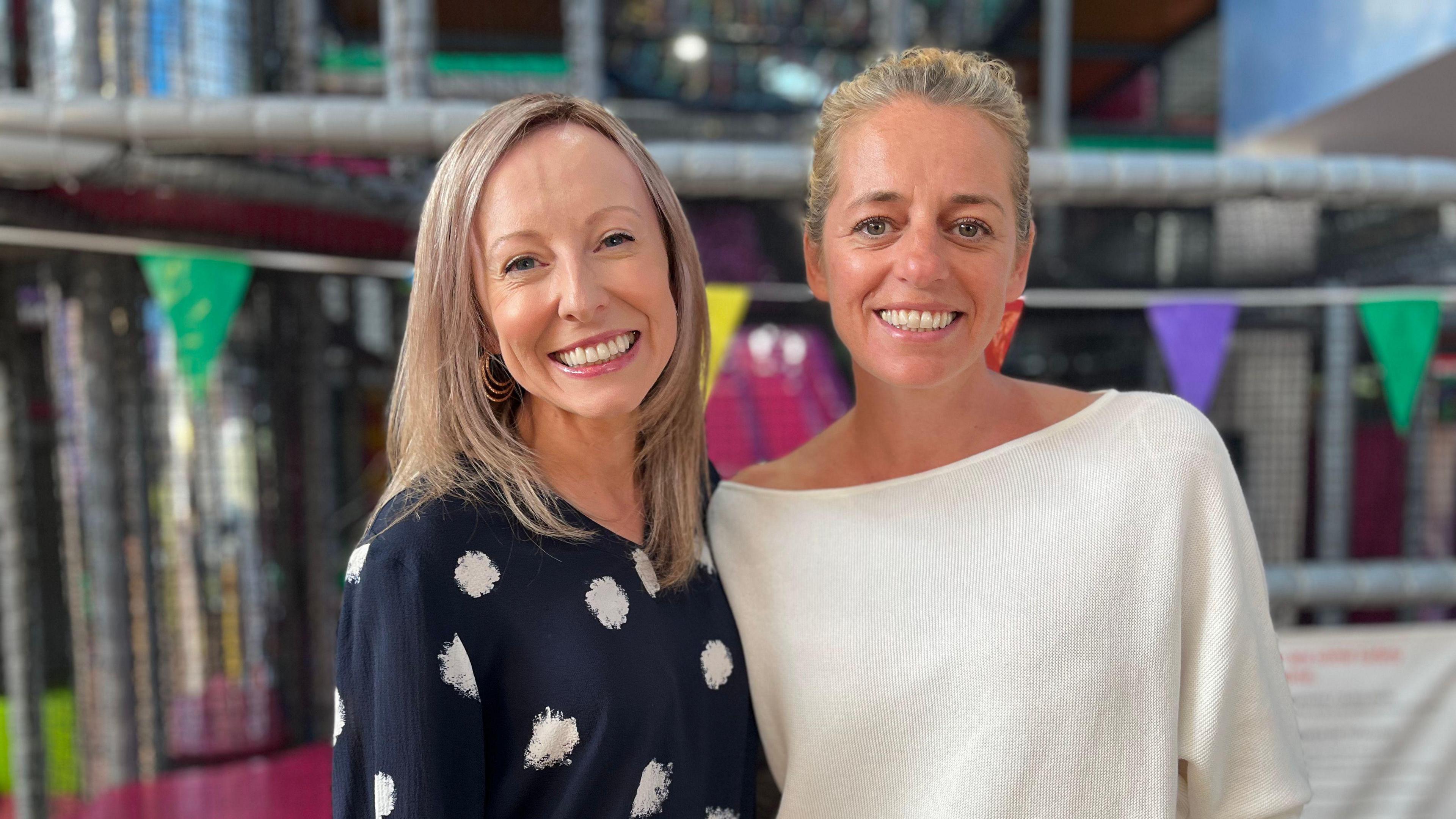 Two smiling women.