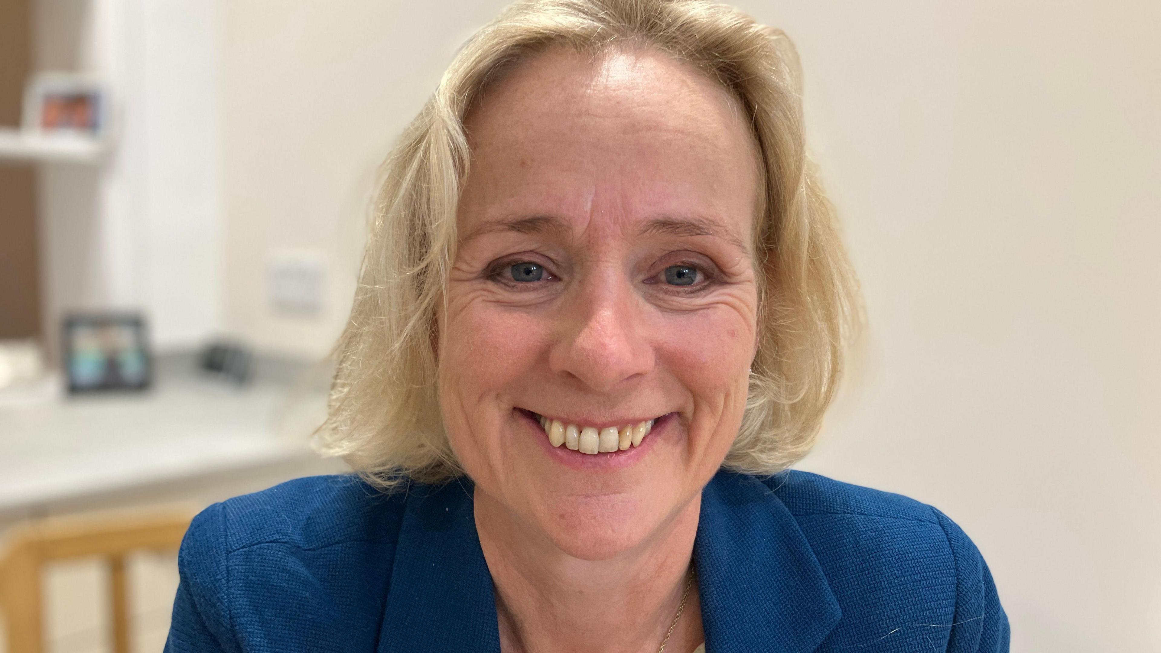 A head-and-shoulders picture of Vicky Ford, the former MP for Chelmsford. She has shoulder-length blonde hair and is smiling at the camera. She is wearing a blue jacket.