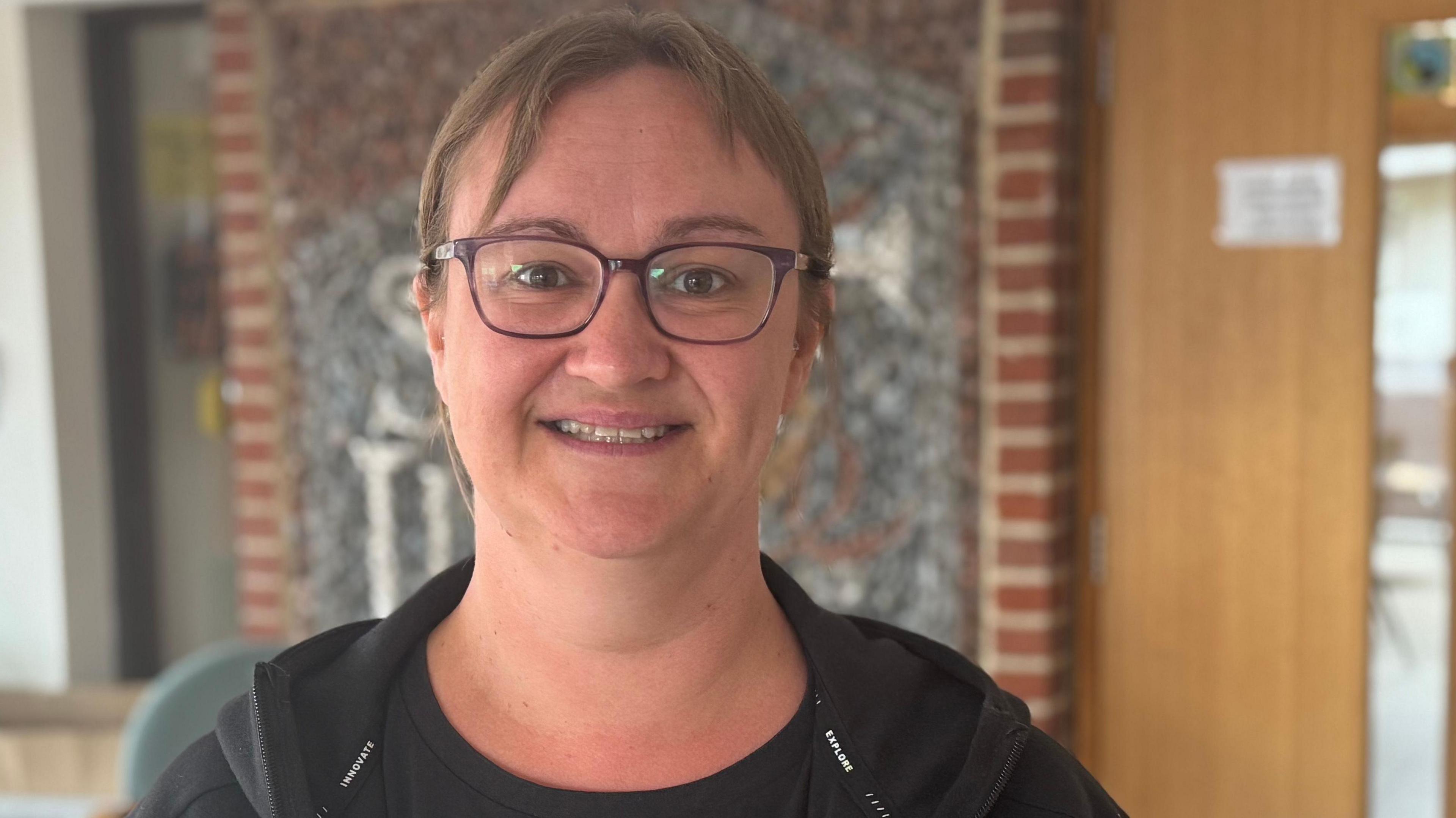 A head and shoulders image of Laura Brockwell. She is wearing glasses and looking into the camera.