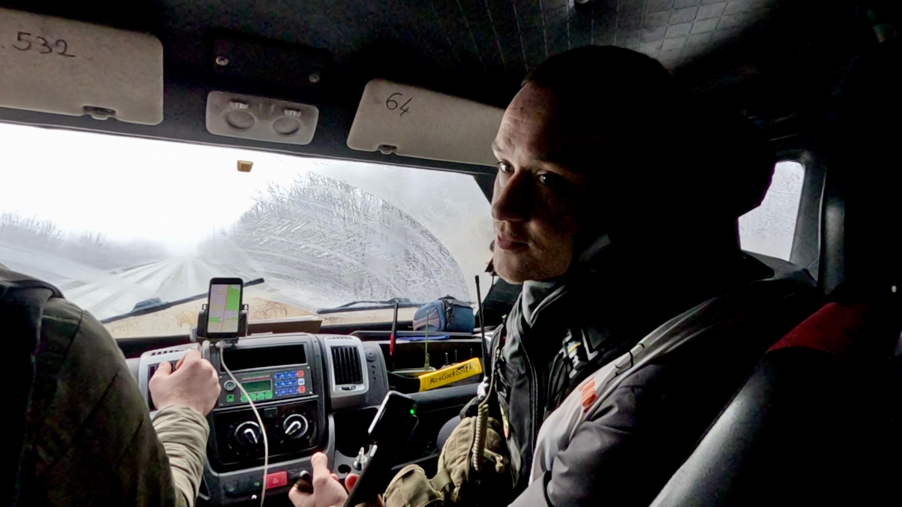 Anton Yaremchuk sits in the passenger side of a vehicle and looks back at the camera