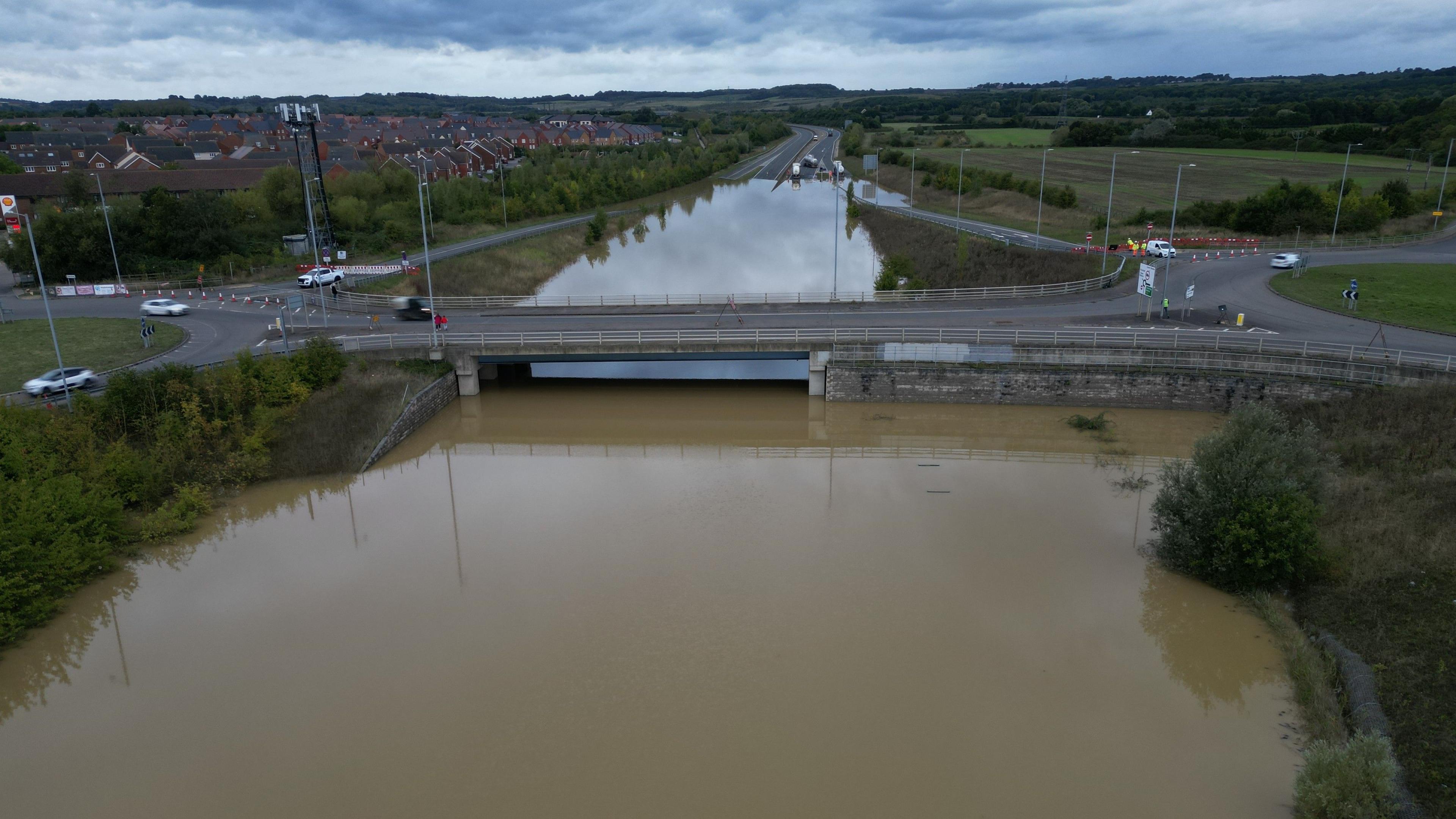 A dual carriageway wholly  covered by flood h2o  nether  a bridge