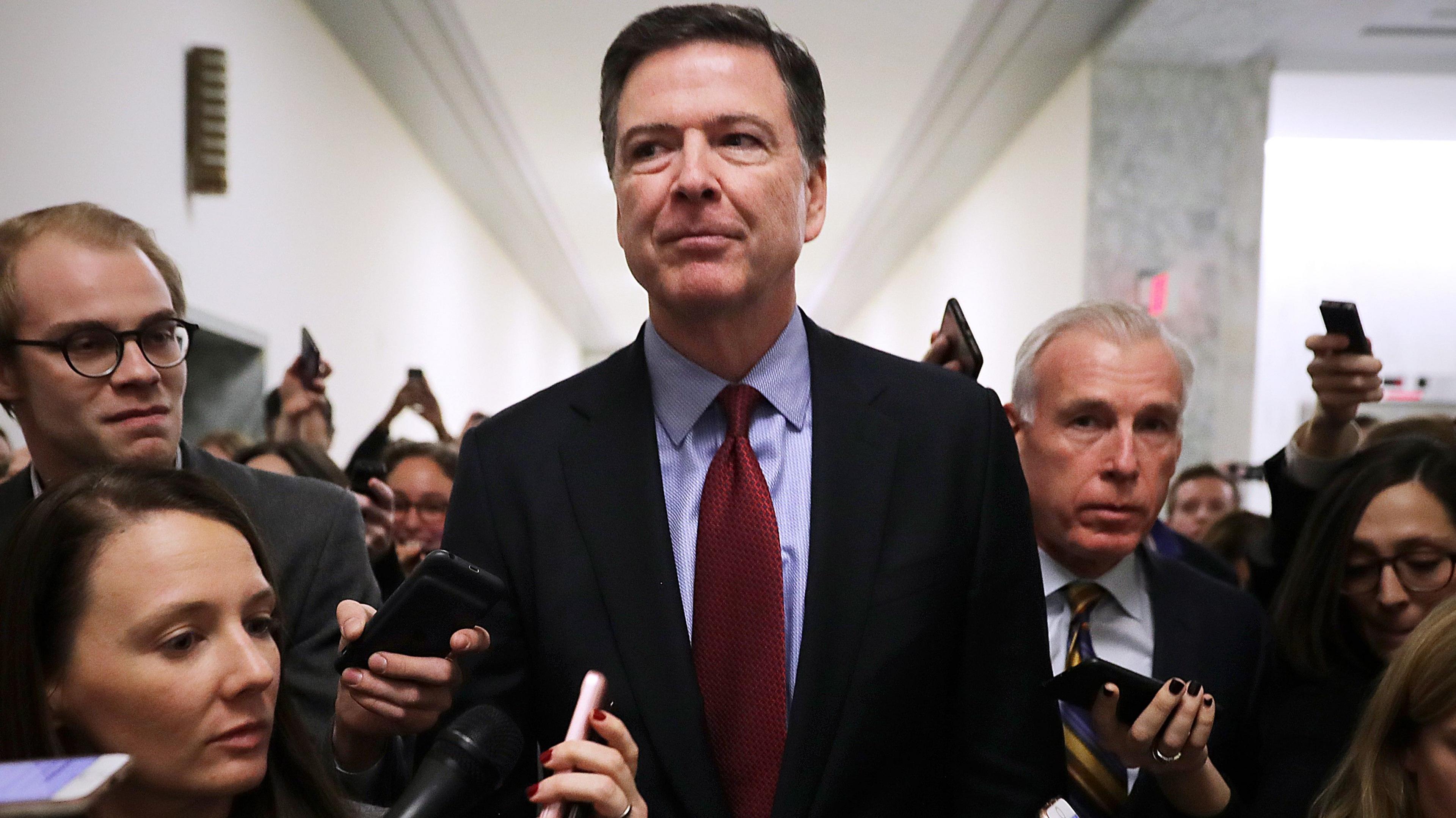 Comey is questioned by reporters outside of a congressional committee hearing in 2018