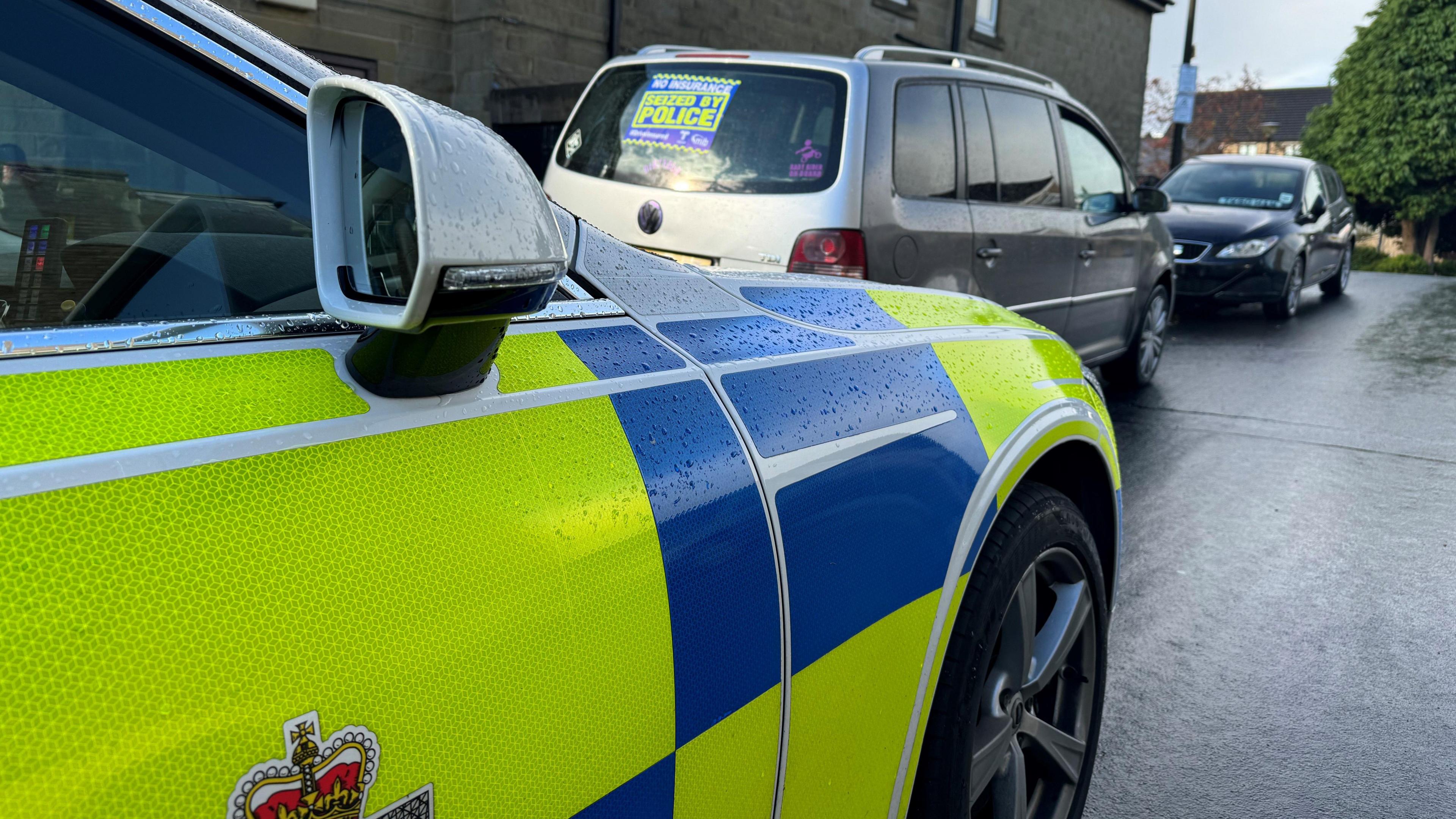 a police car parked behind a van 