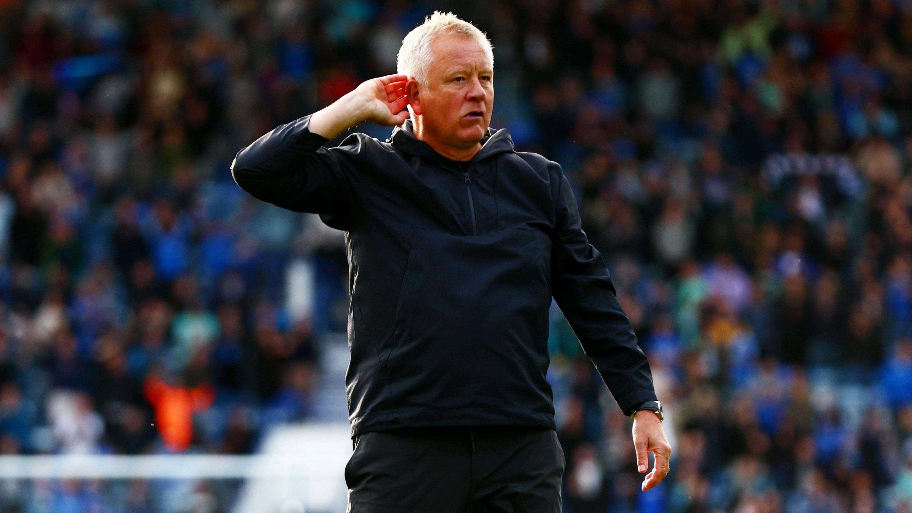 Chris Wilder cups his ear to the crowd