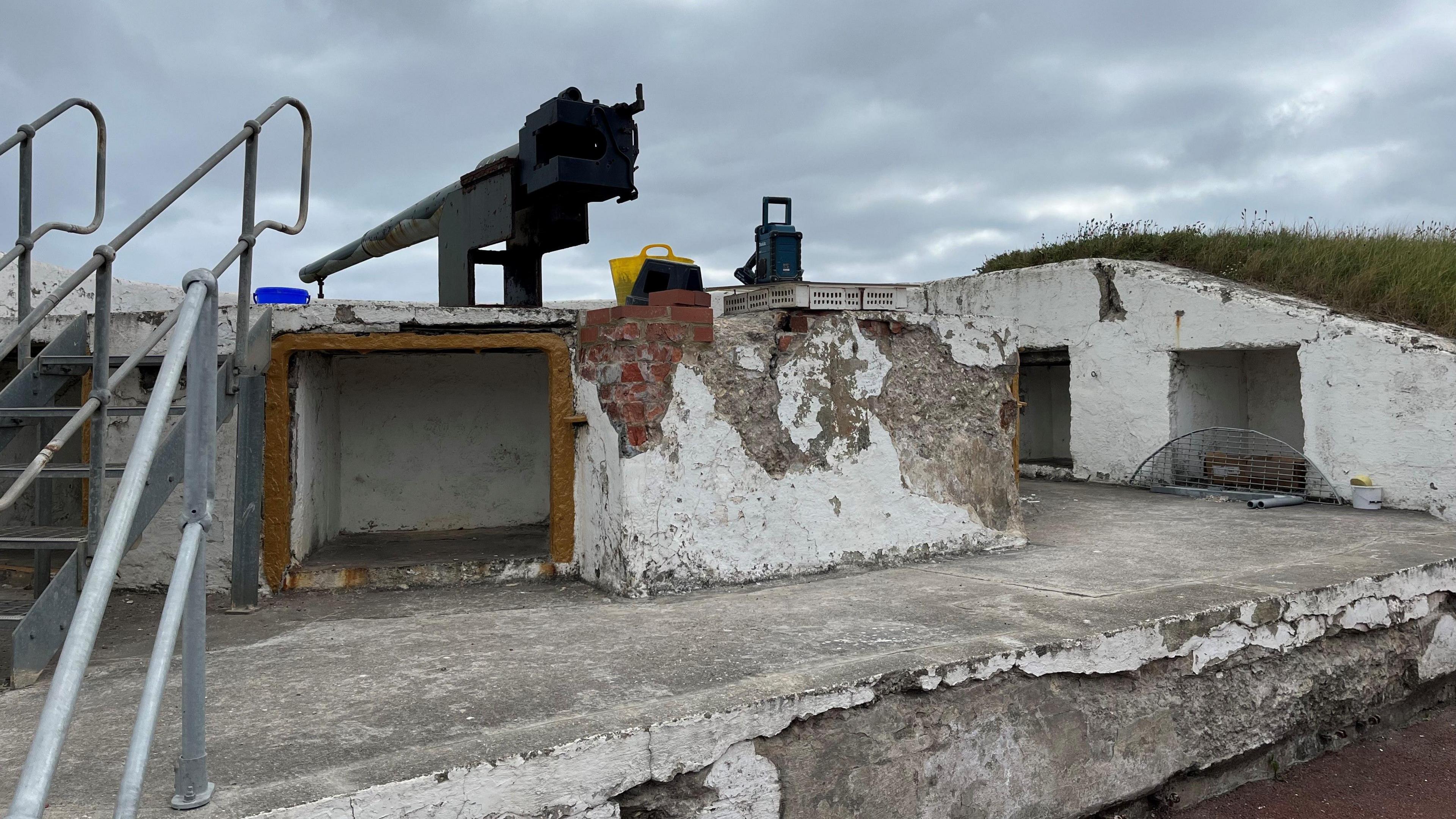 A concrete gunning placement. The white concrete is cracked and decaying.