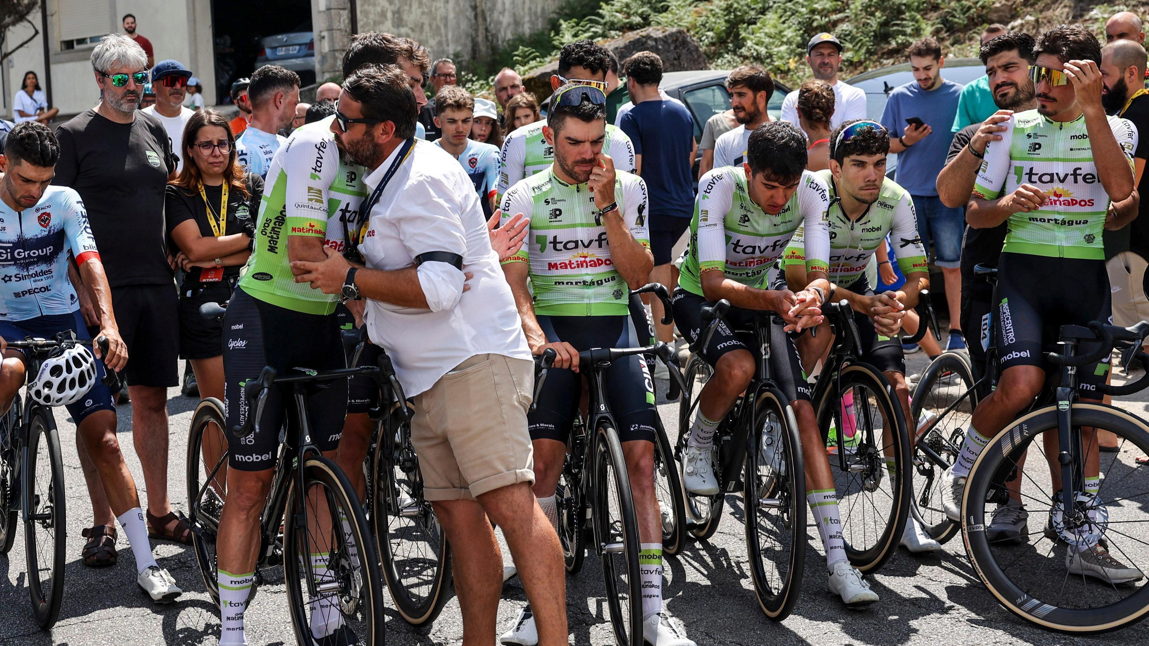 cyclists consoling one another