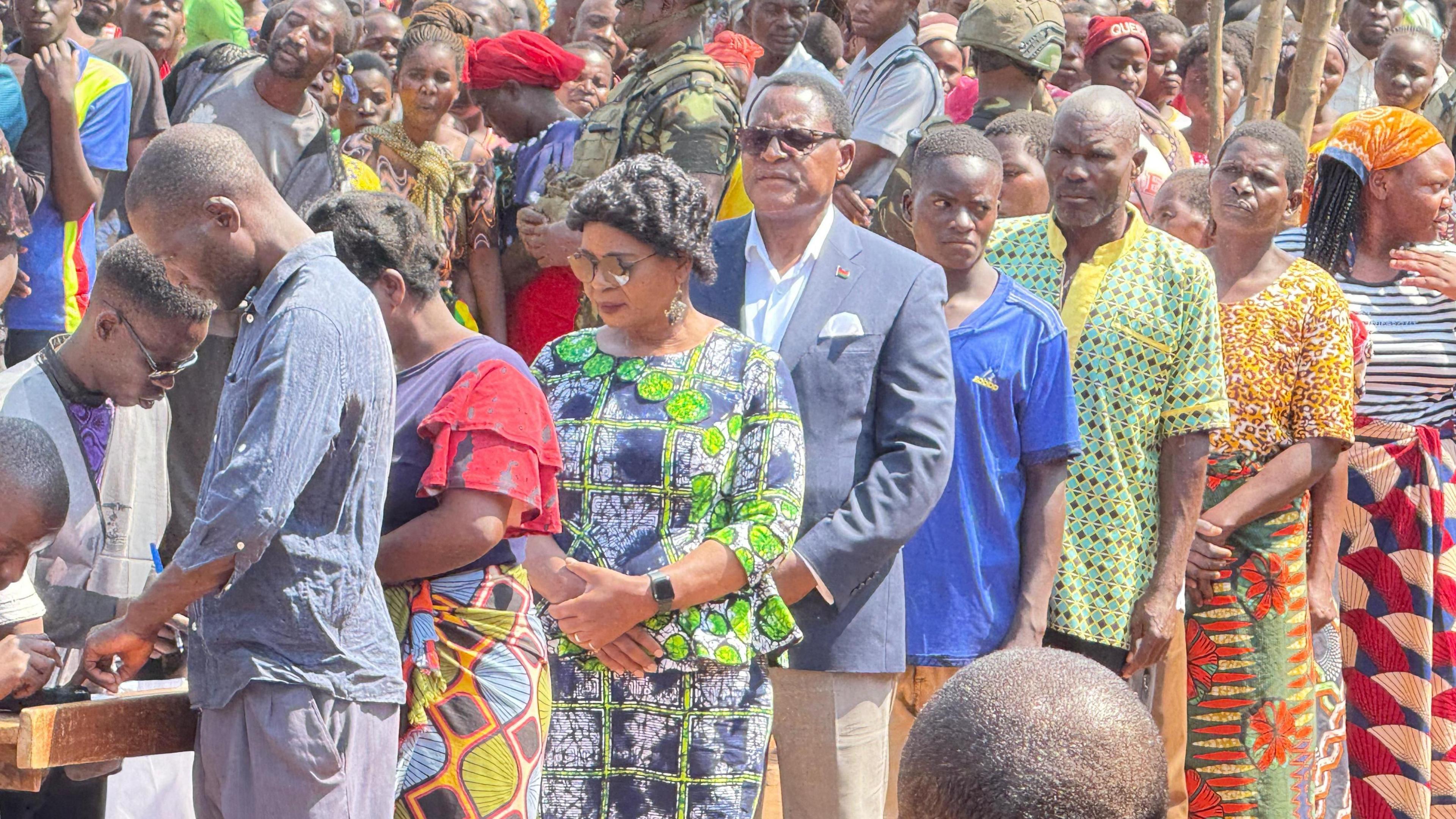 Lazarus Chakwera waits to vote in an outdoor, tightly packed queue.