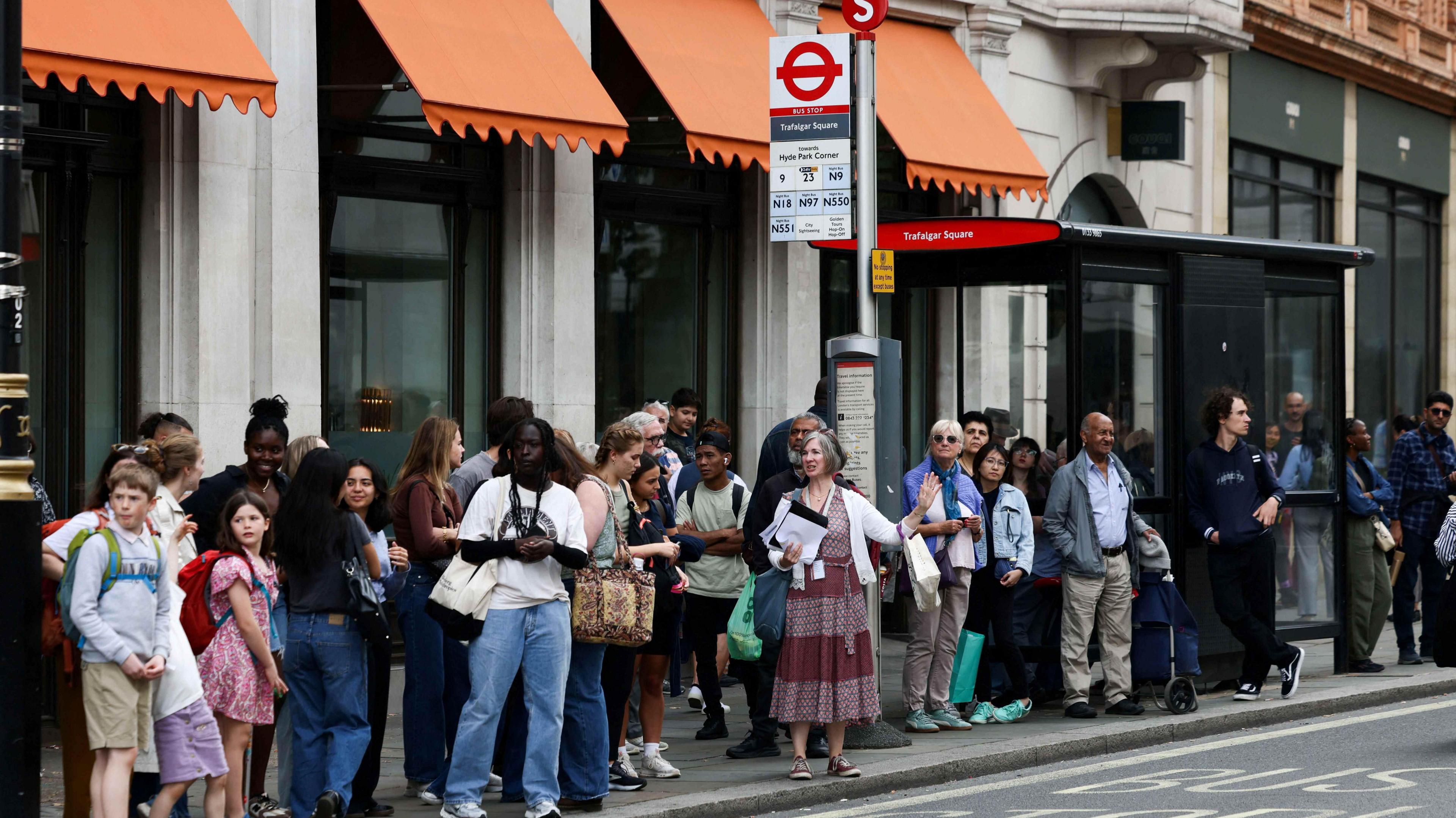 people waiting in the queue for a bus
