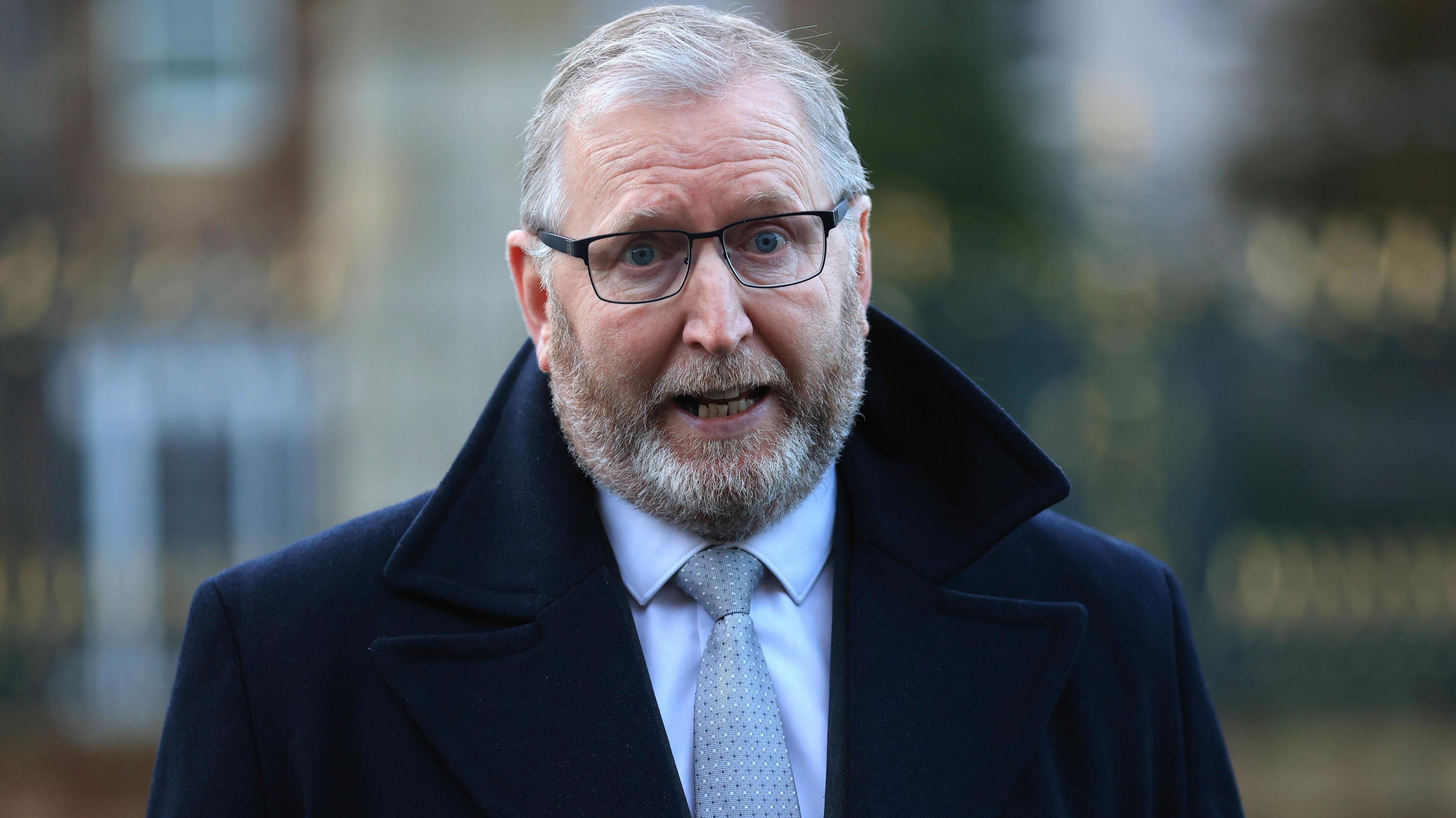 Doug Beattie wearing an overcoat, shirt and tie. 